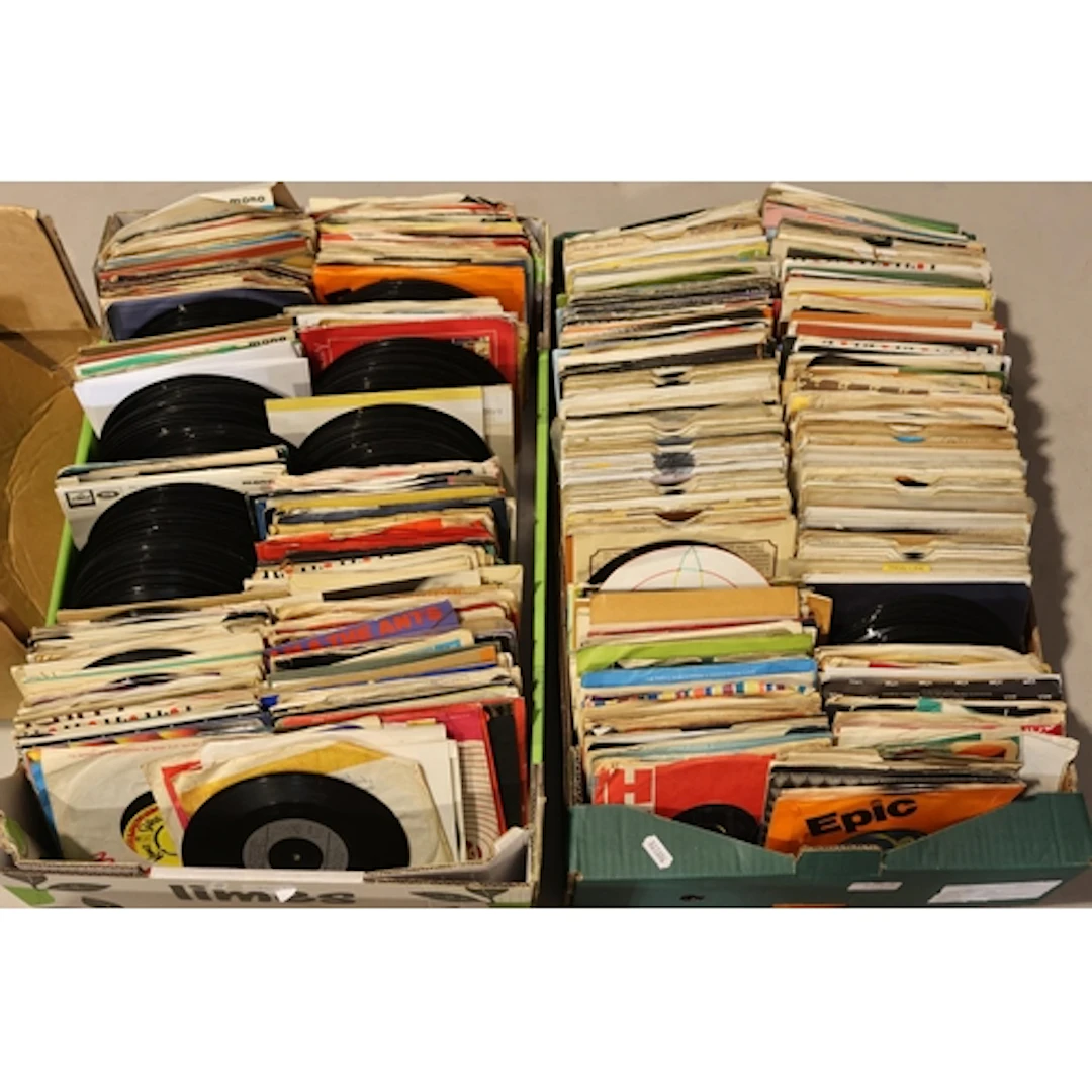 Two boxes containing a large quantity of mixed 7'' singles.