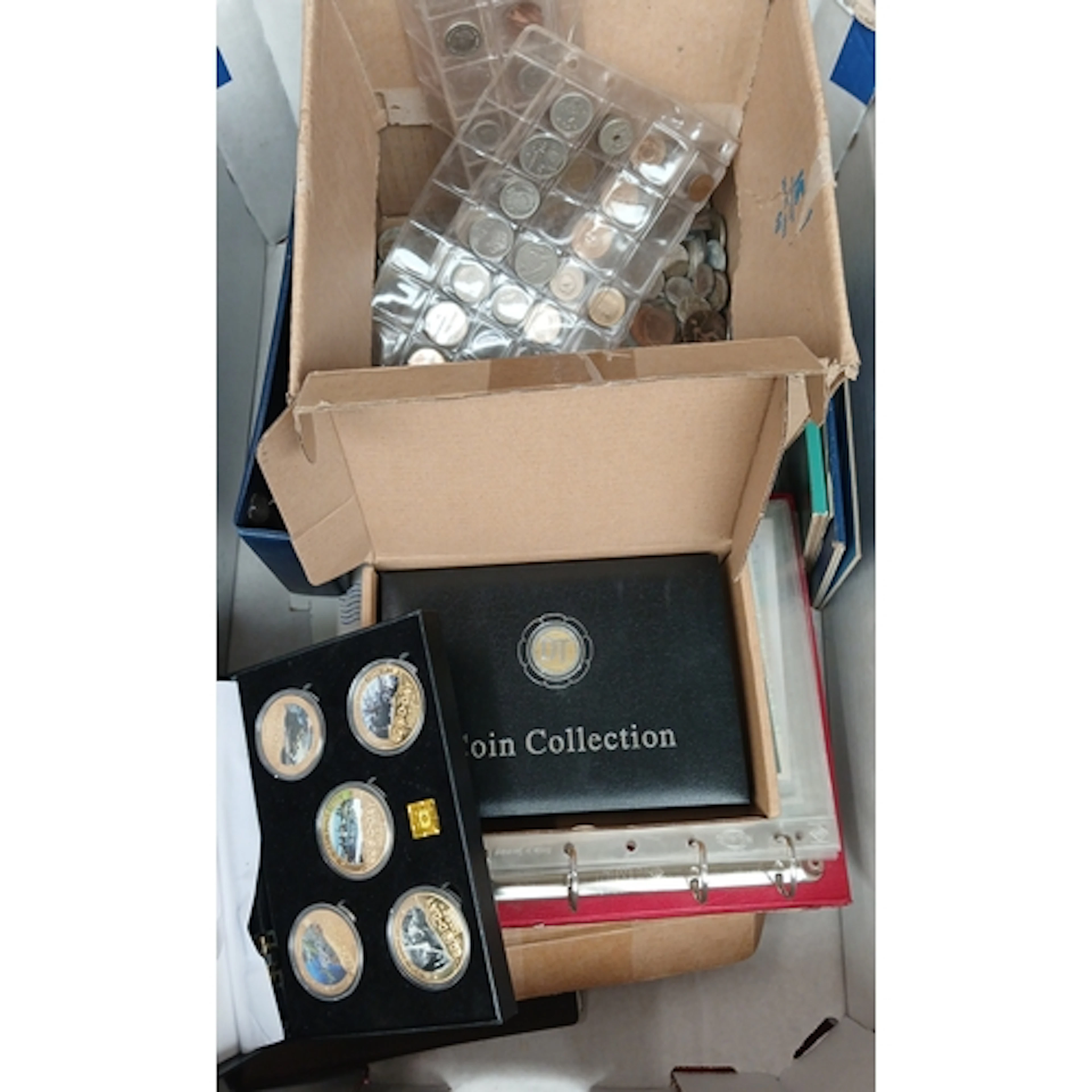 A box of assorted world coins & banknotes to include Whitman...