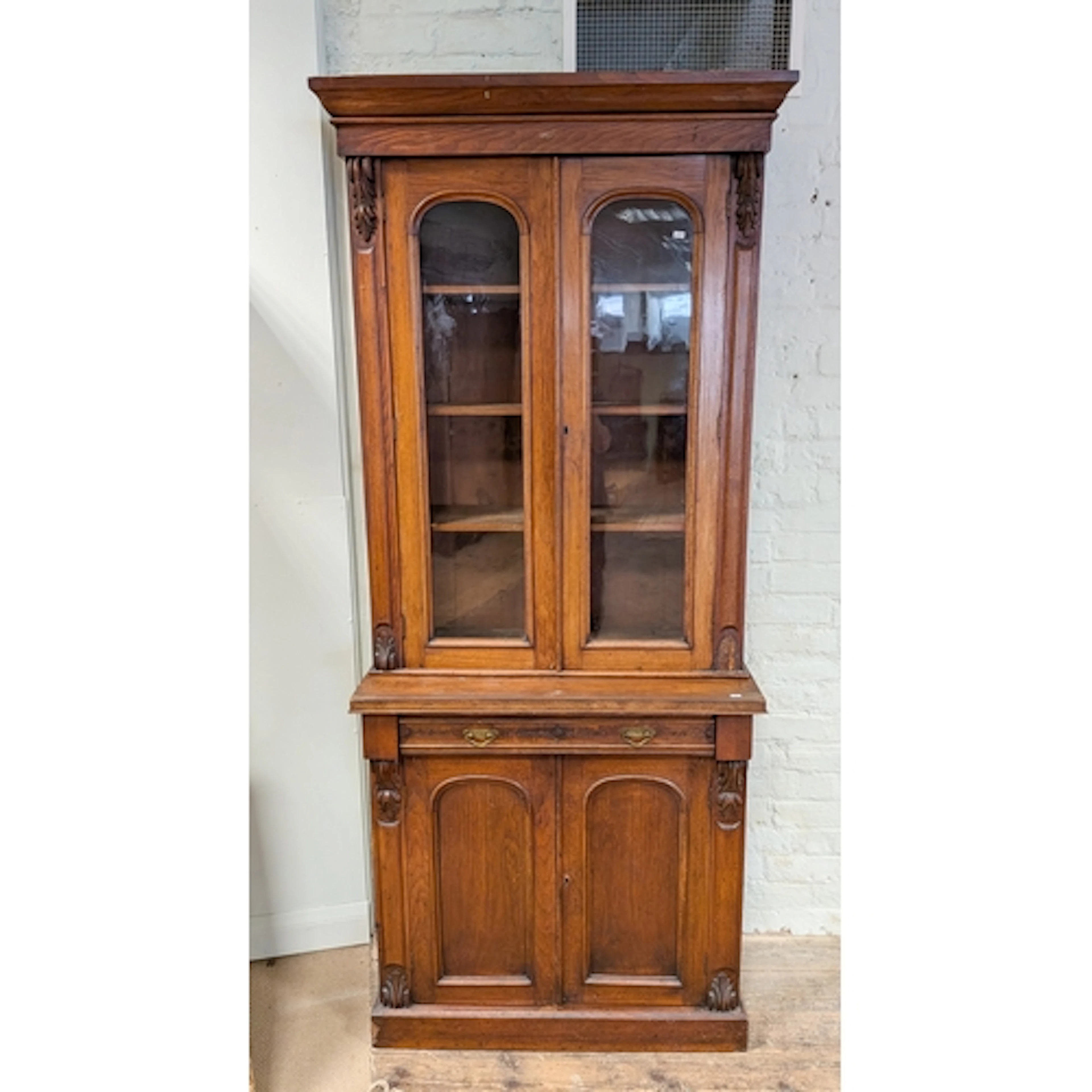 A Victorian mahogany glazed top bookcase, the base fitted on...