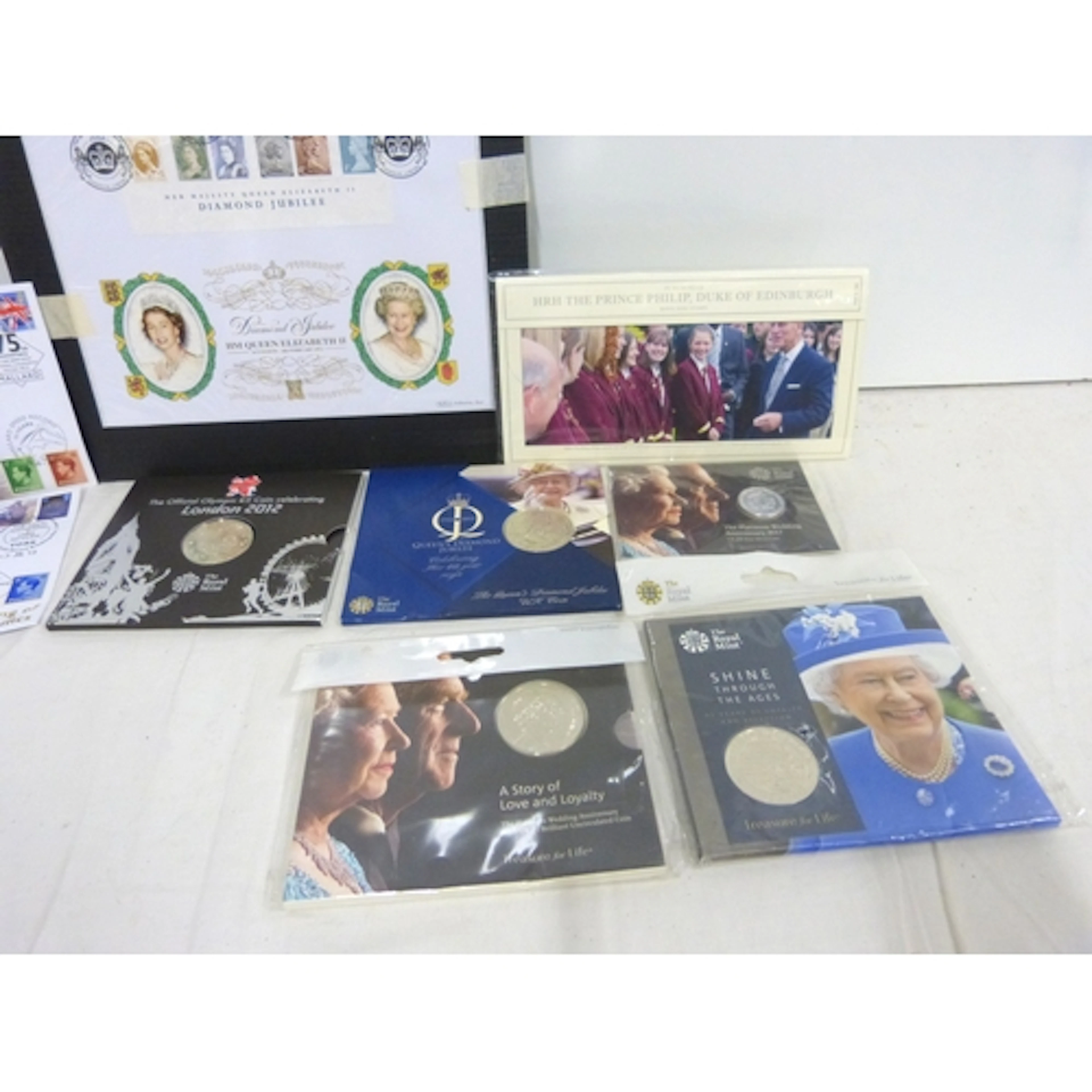 Collection of various commemorative coins and First Day Cove...