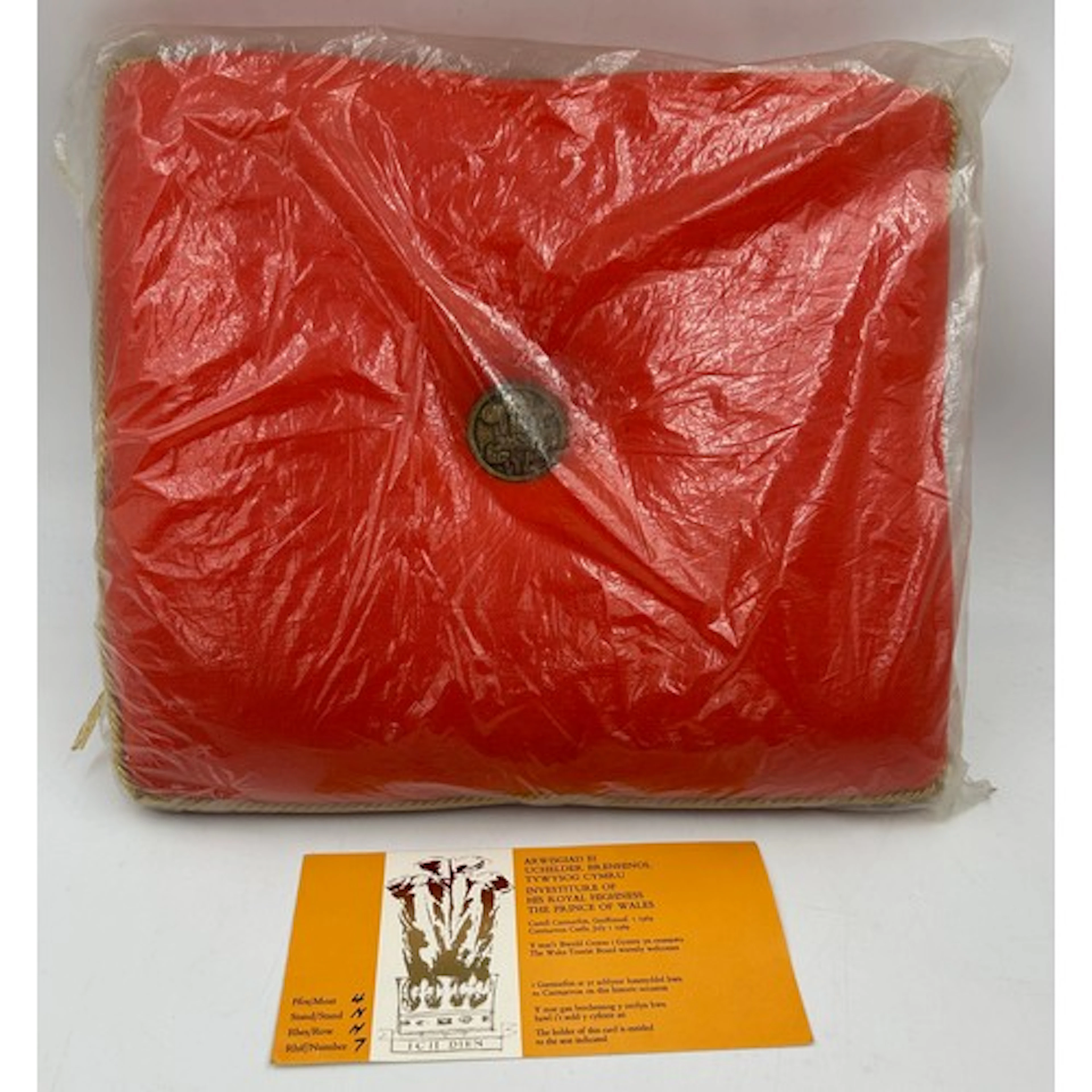 A Royal Cushion, red with gold trim, from the Investiture of...