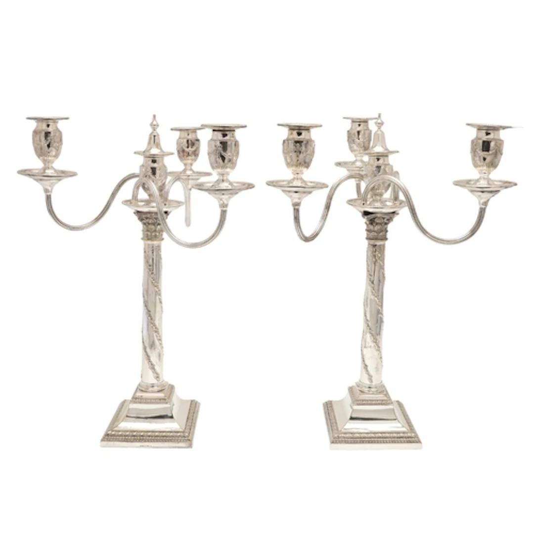 A PAIR OF SILVER PLATED THREE BRANCH CANDELABRA. The tops ma...