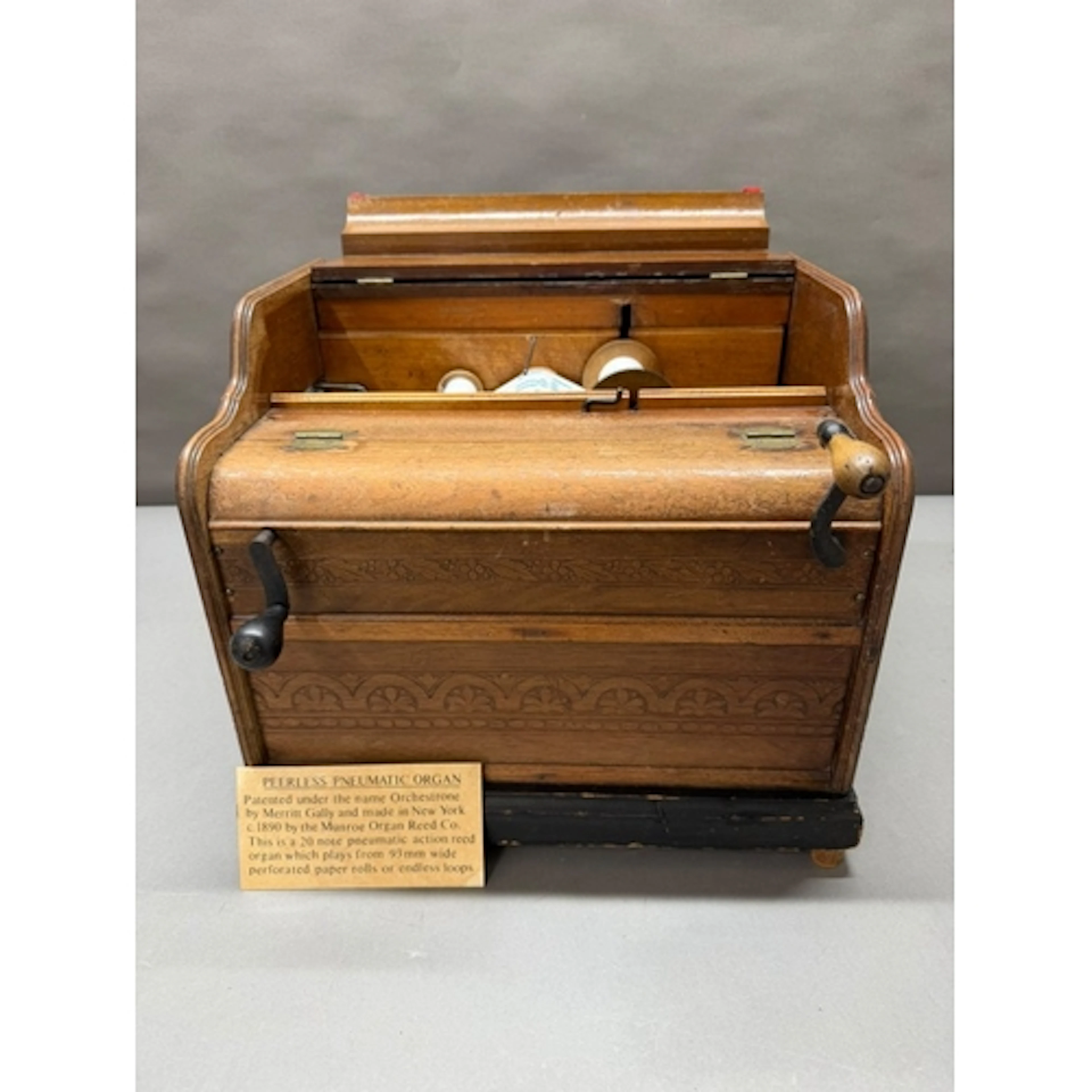 A Peerles Pneumatic Organ with assorted music rolls.