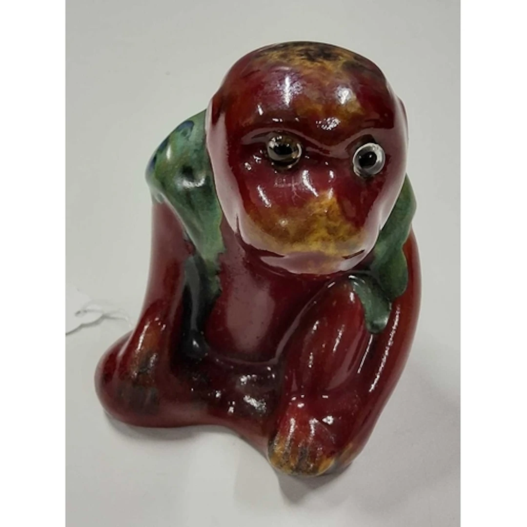 A BERNARD MOORE MONKEY FIGURE, the hollow figure of a seated...