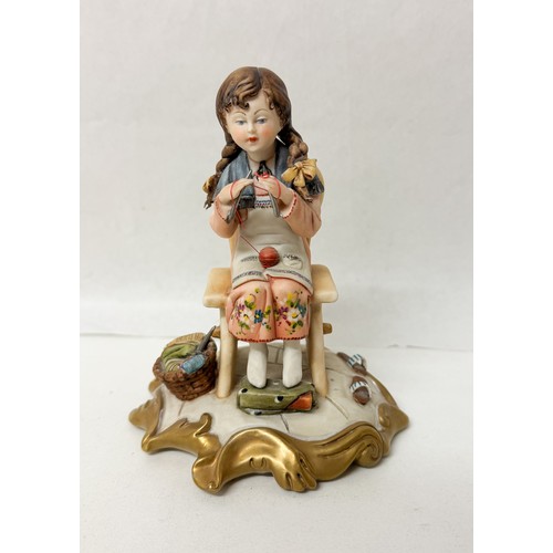 A Capodimonte porcelain figurine of a girl knitting, known a...