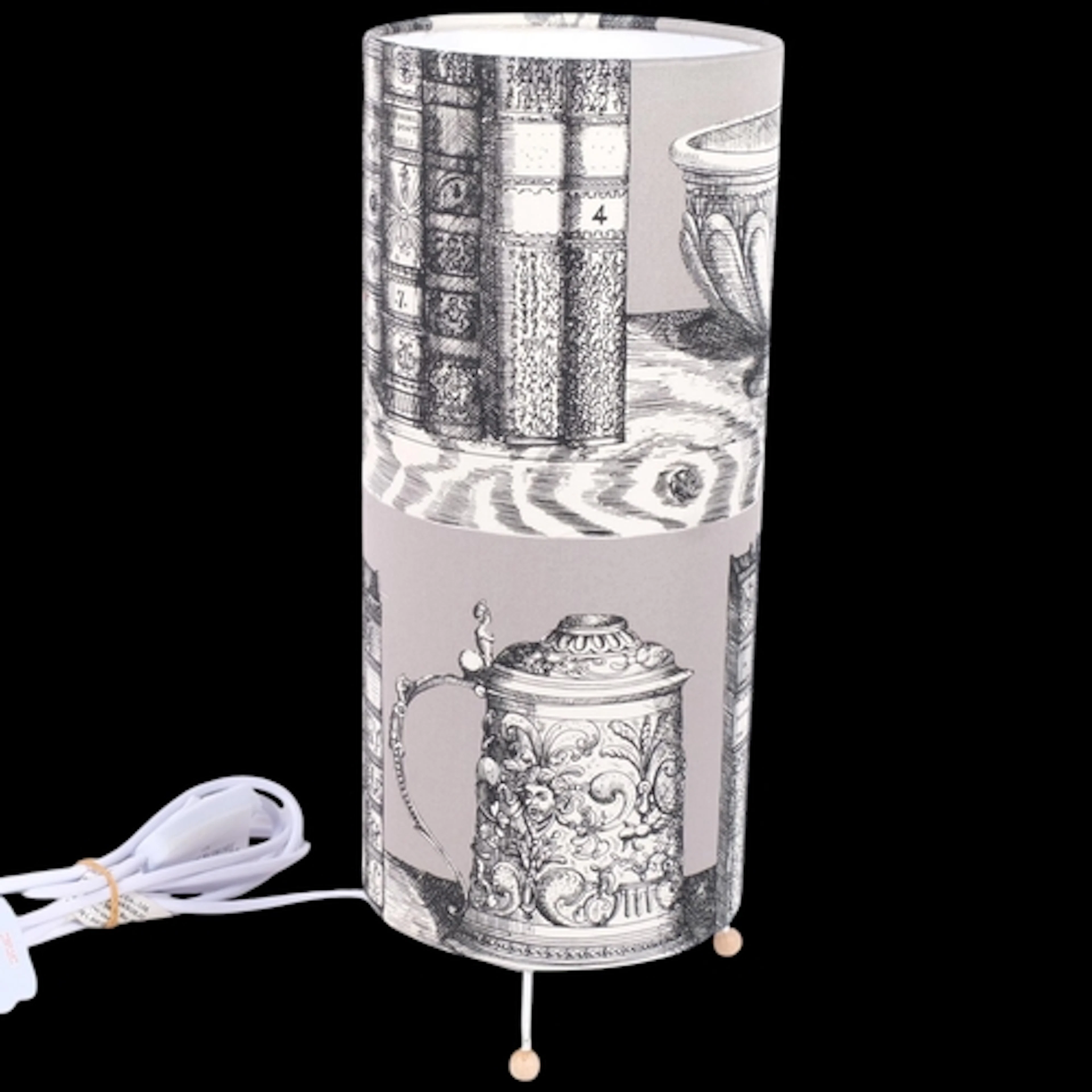 A modern table lamp, with Fornasetti style shade, on wooden ...