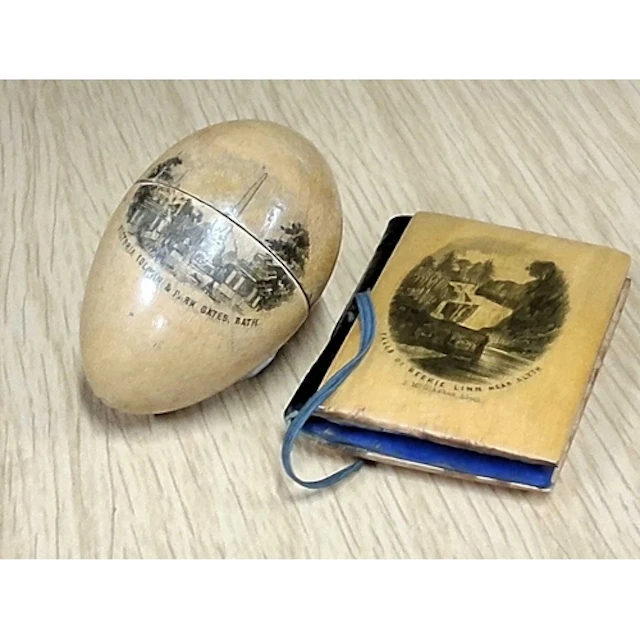 TWO MAUCHLINE WARE SEWING CASES, comprising an ovoid thimble...