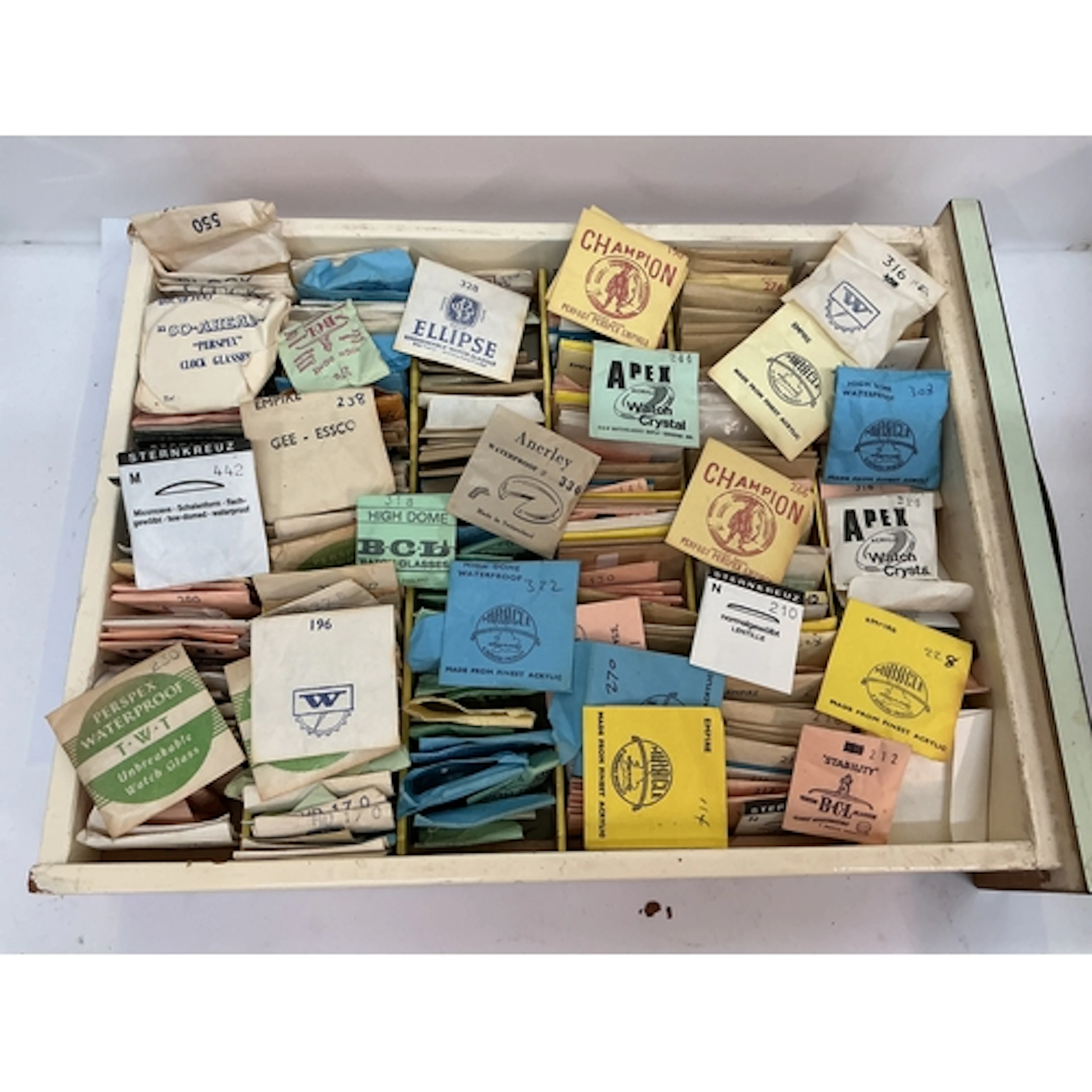 A tray containing vintage watch glasses