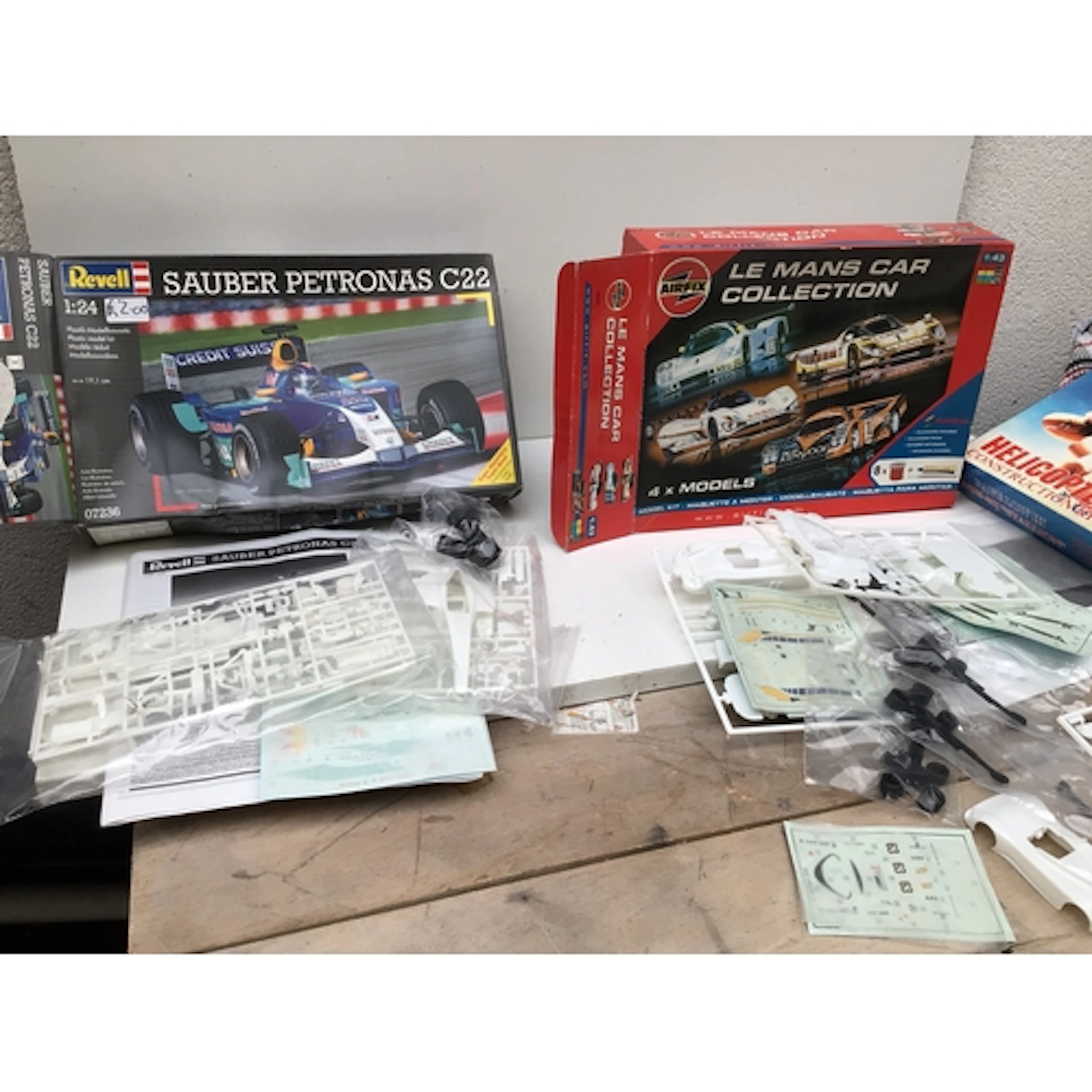 A collection of boxed model kits featuring aircraft and cars...