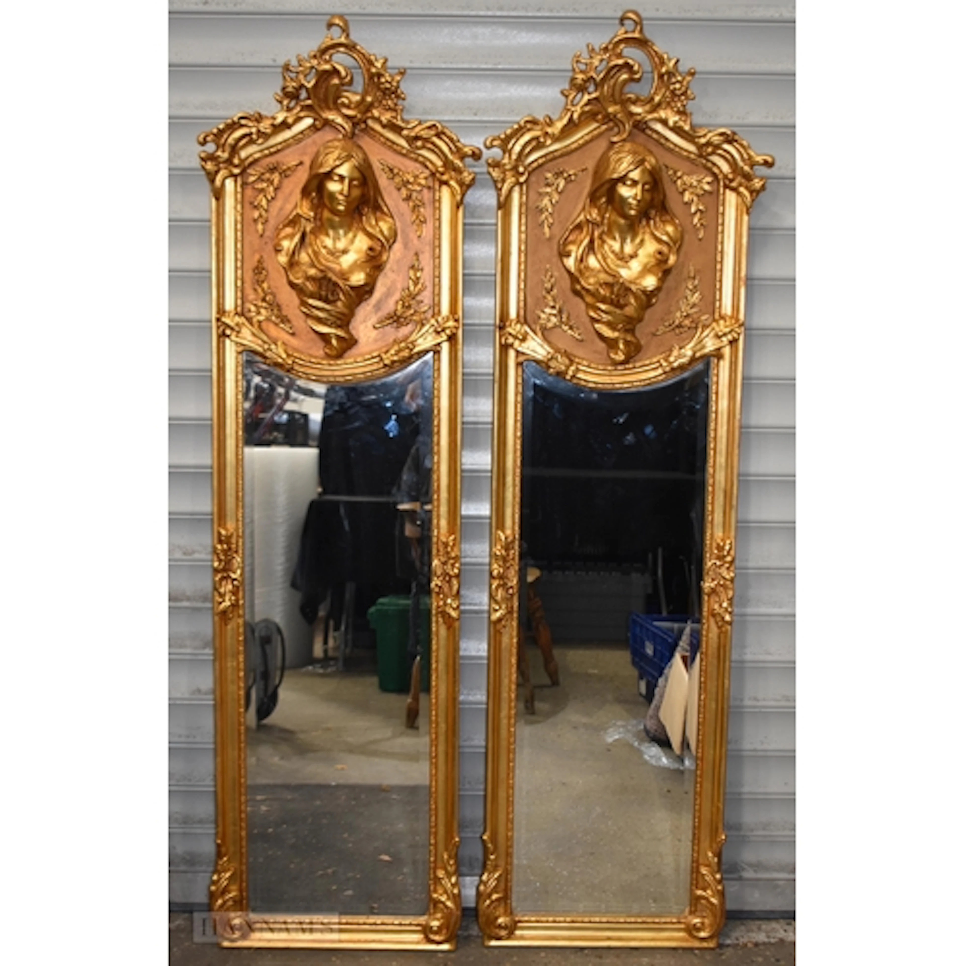 A pair of baroque style giltwood framed mirrors with relief ...