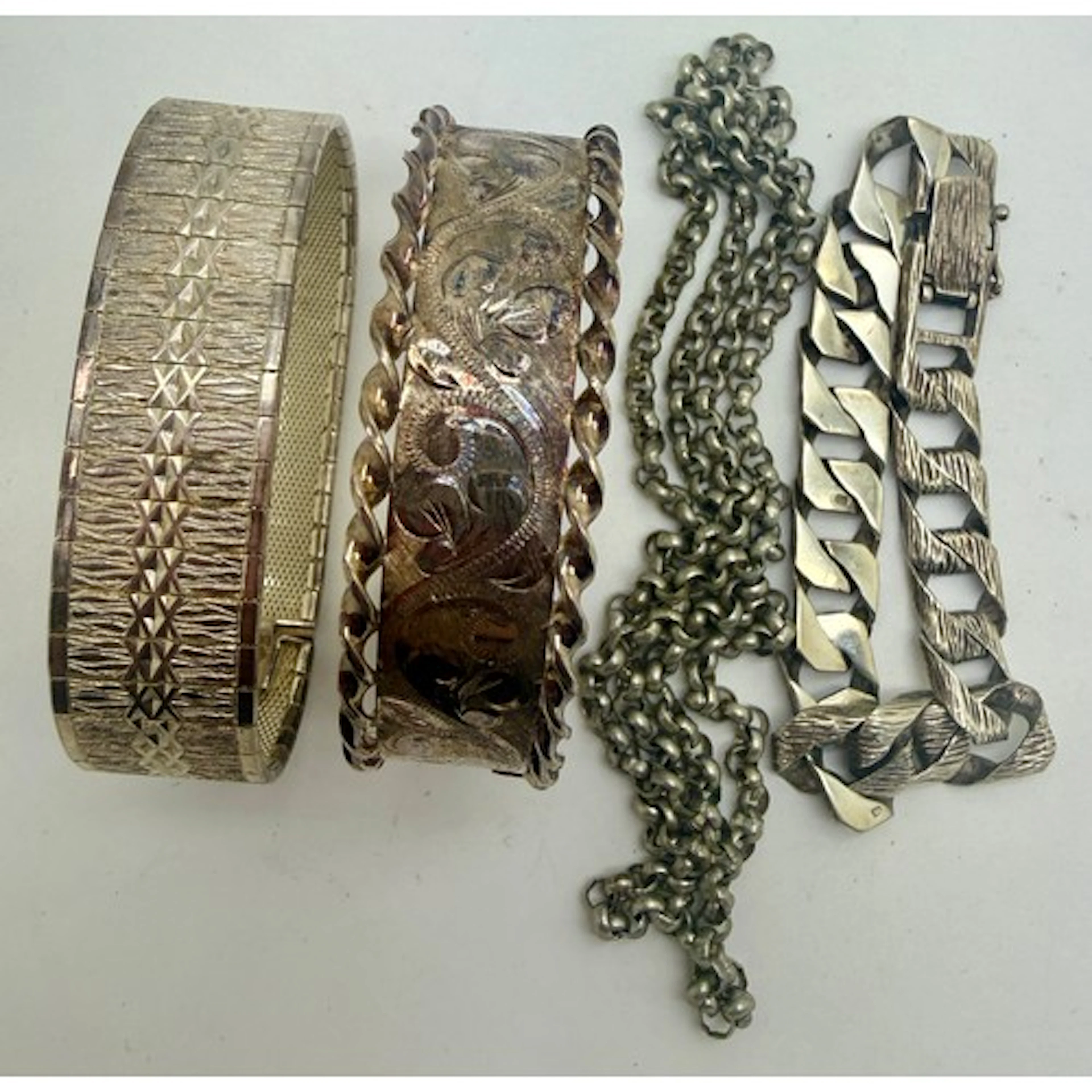 Hallmarked and sterling silver to include two bangles, chain...