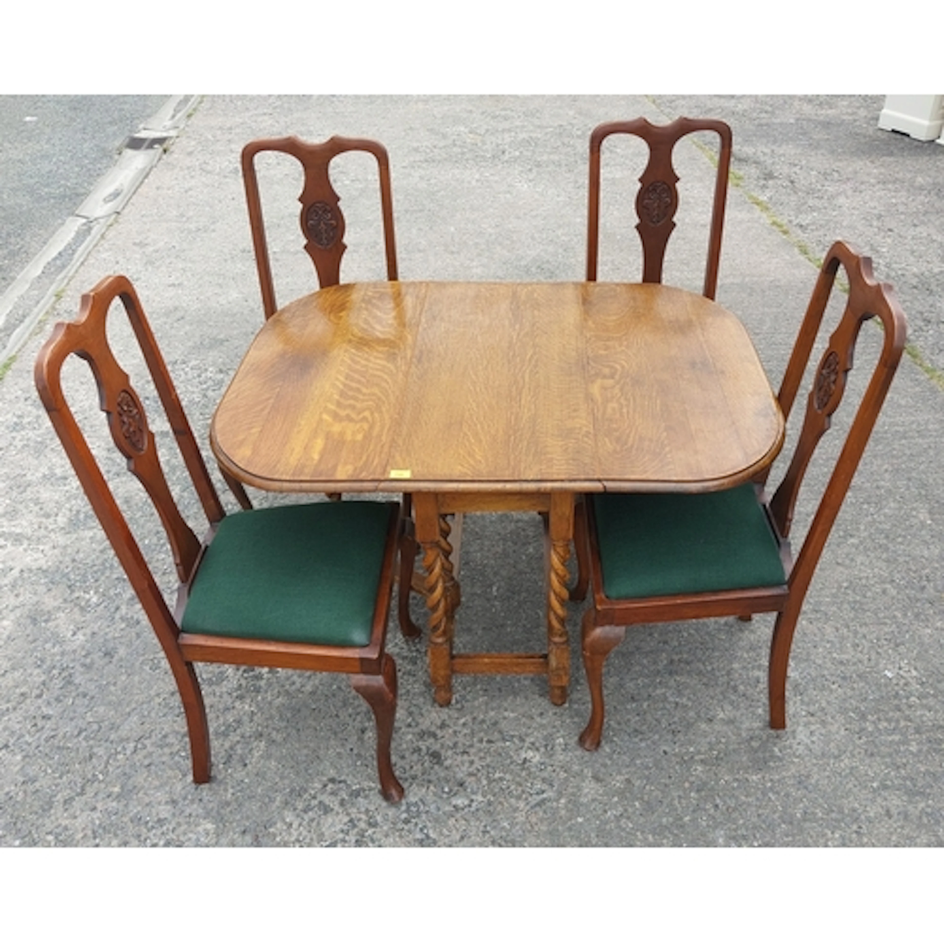 An oak drop leaf gate leg table with barley twist legs and 4...