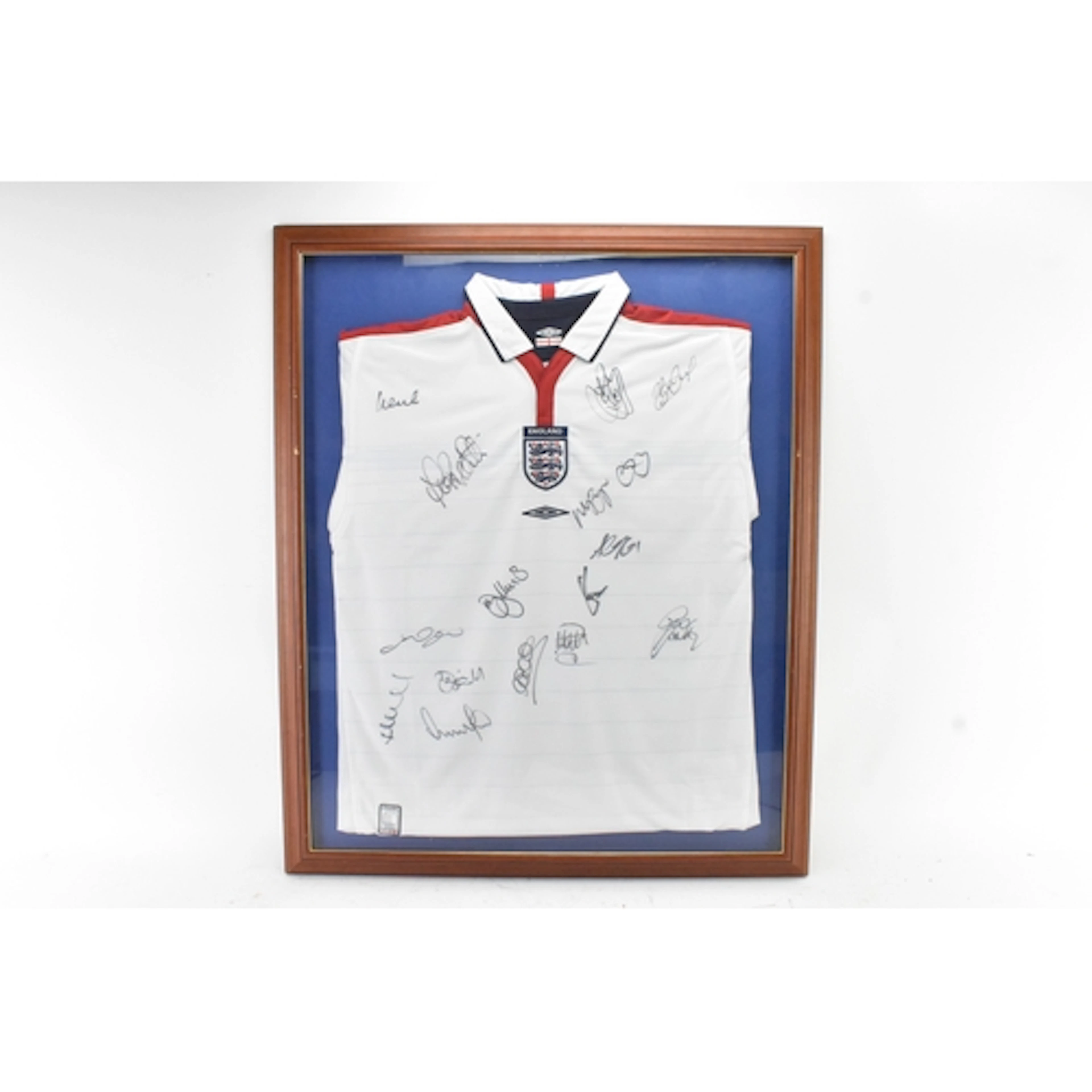 A framed England squad signed Umbro football shirt presentat...