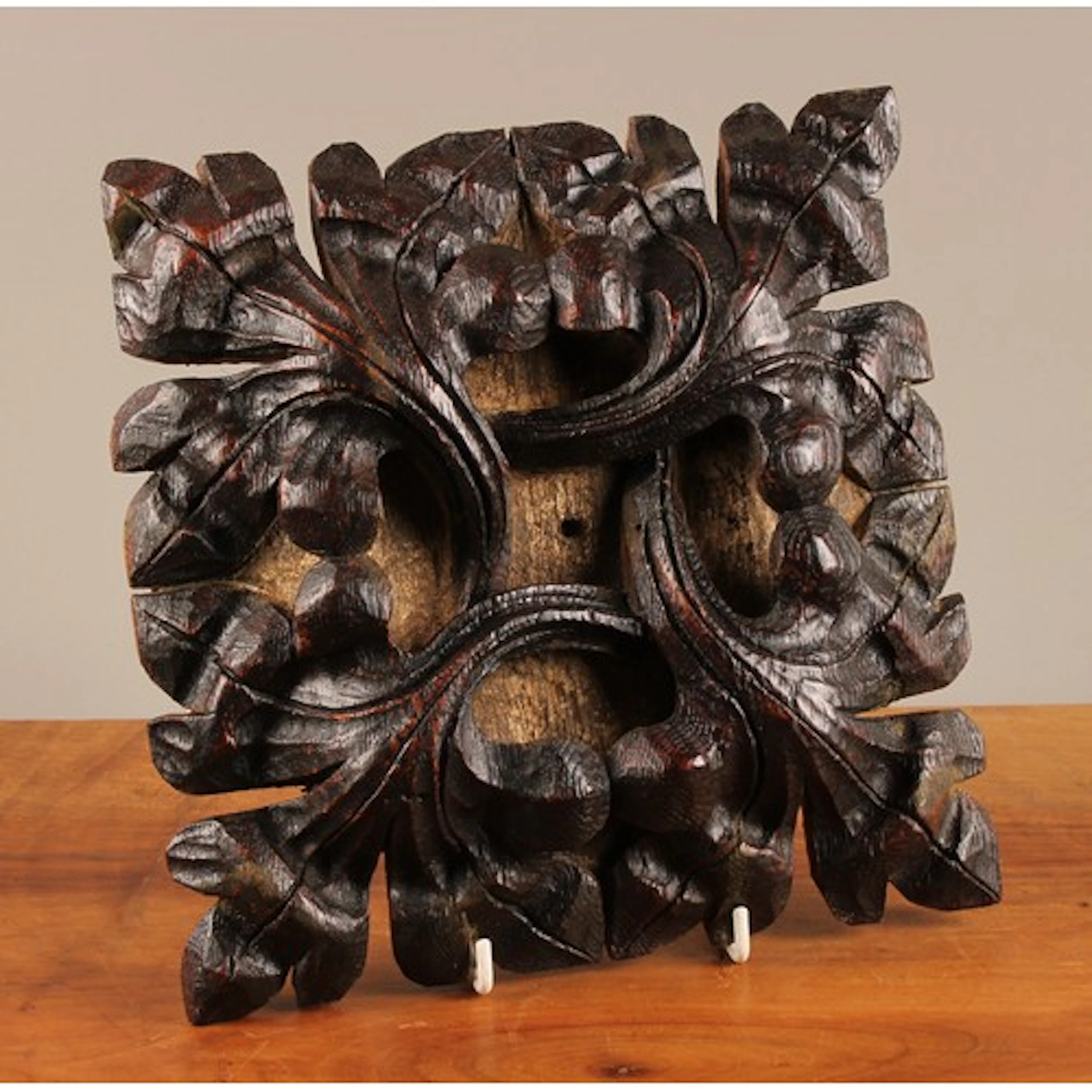 A Tudor Gothic oak roof boss, carved in high relief with aca...
