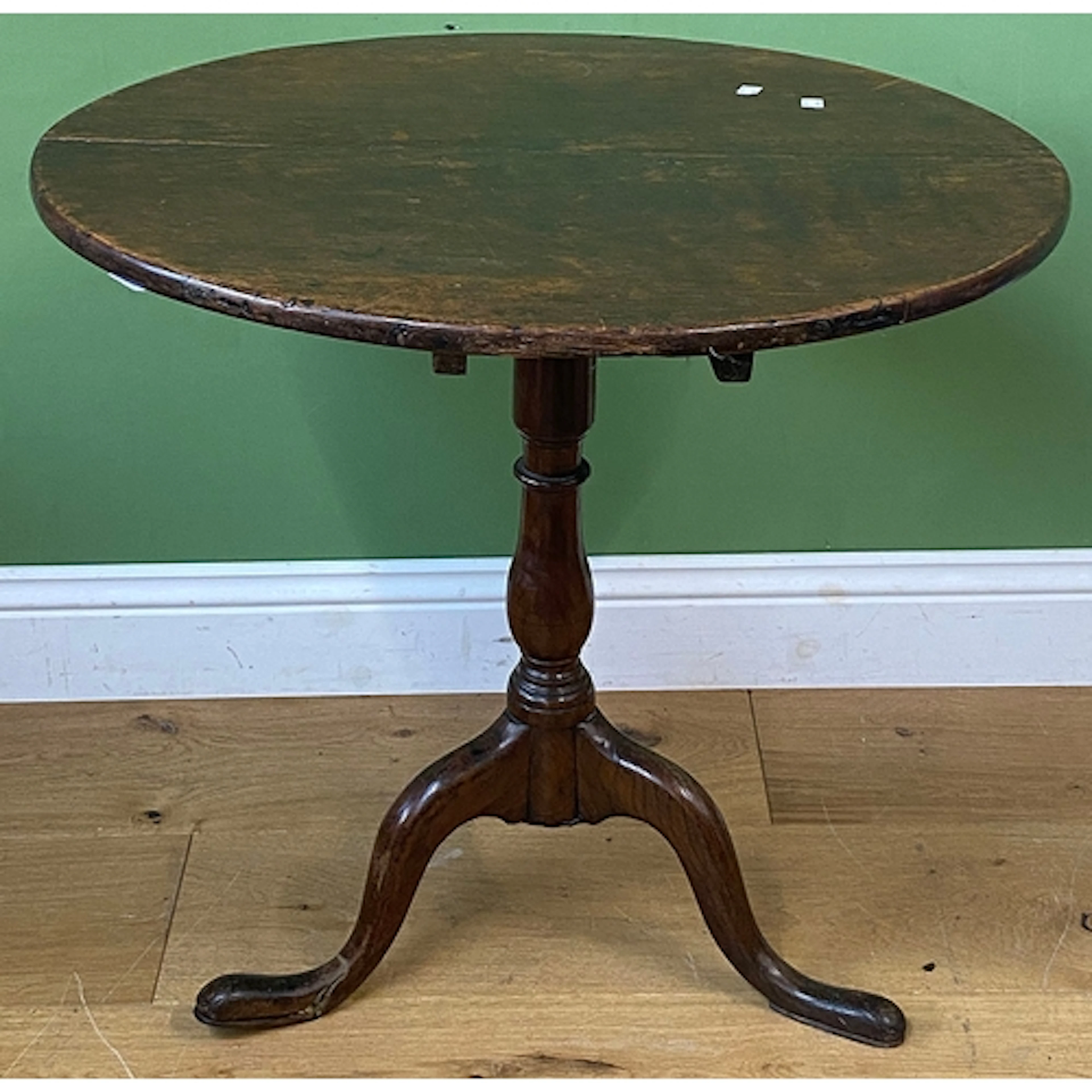 An 18th century occasional table, circular oak top with tilt...