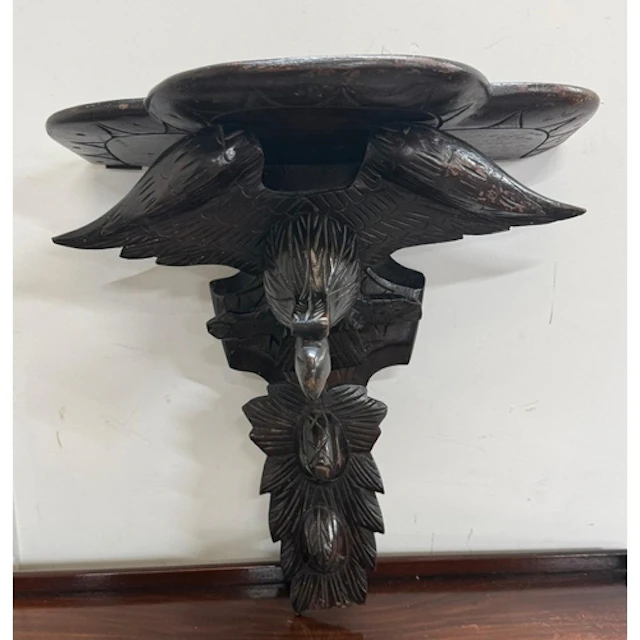 A carved Black Forest wall bracket with eagle detail