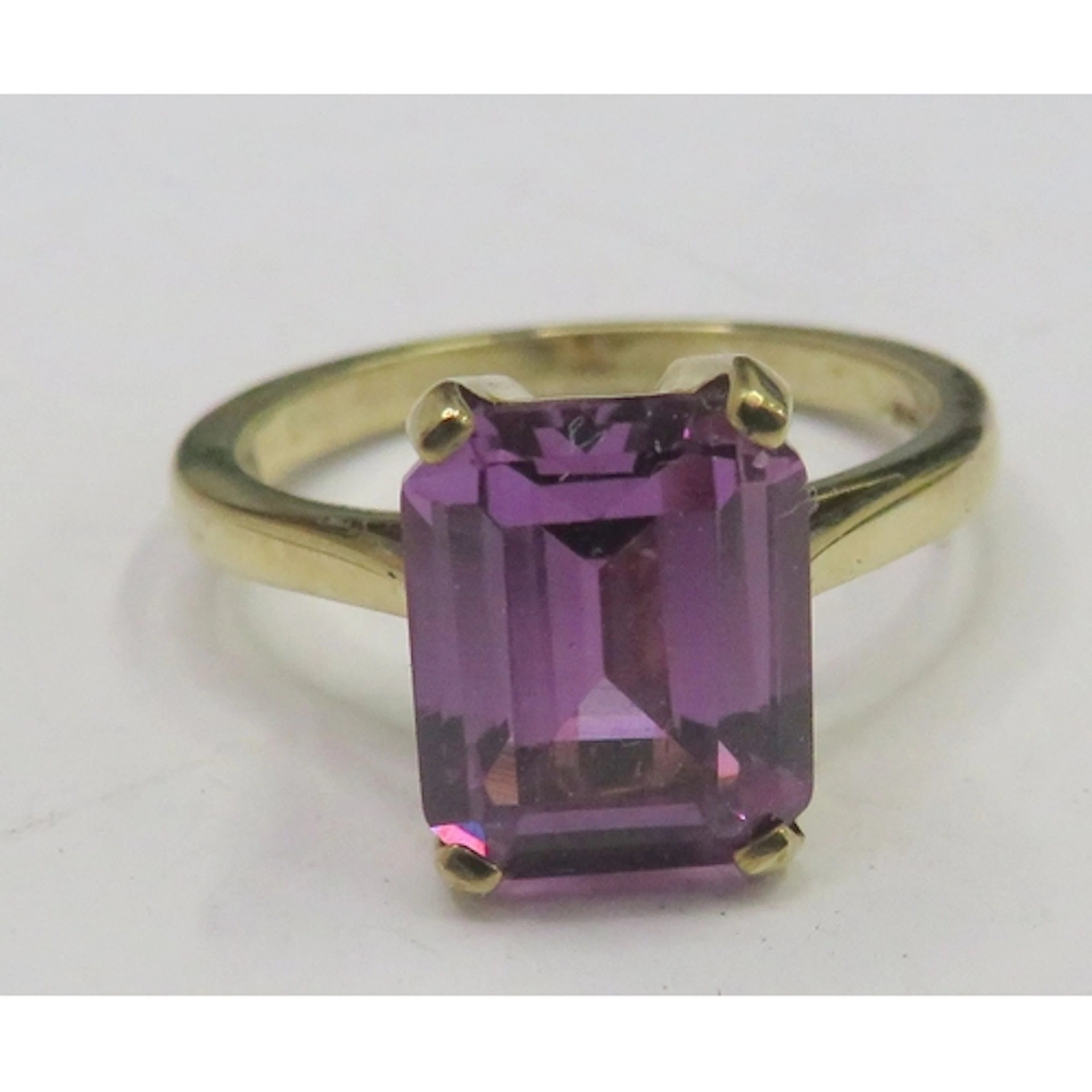 9ct Yellow Gold Dress Ring with large emerald cut purple ale...