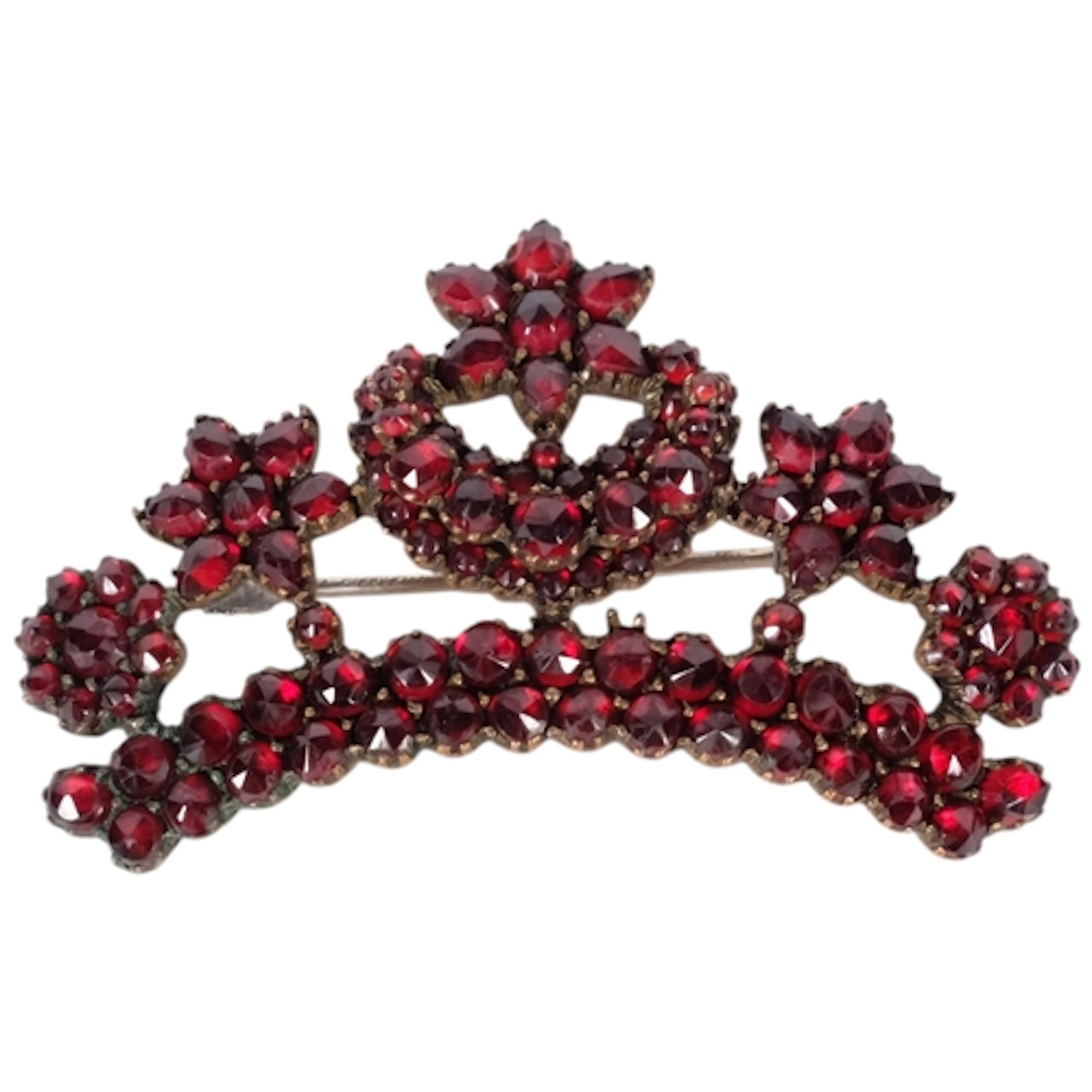 A Bohemian tiara-shaped garnet brooch, with star drop decora...