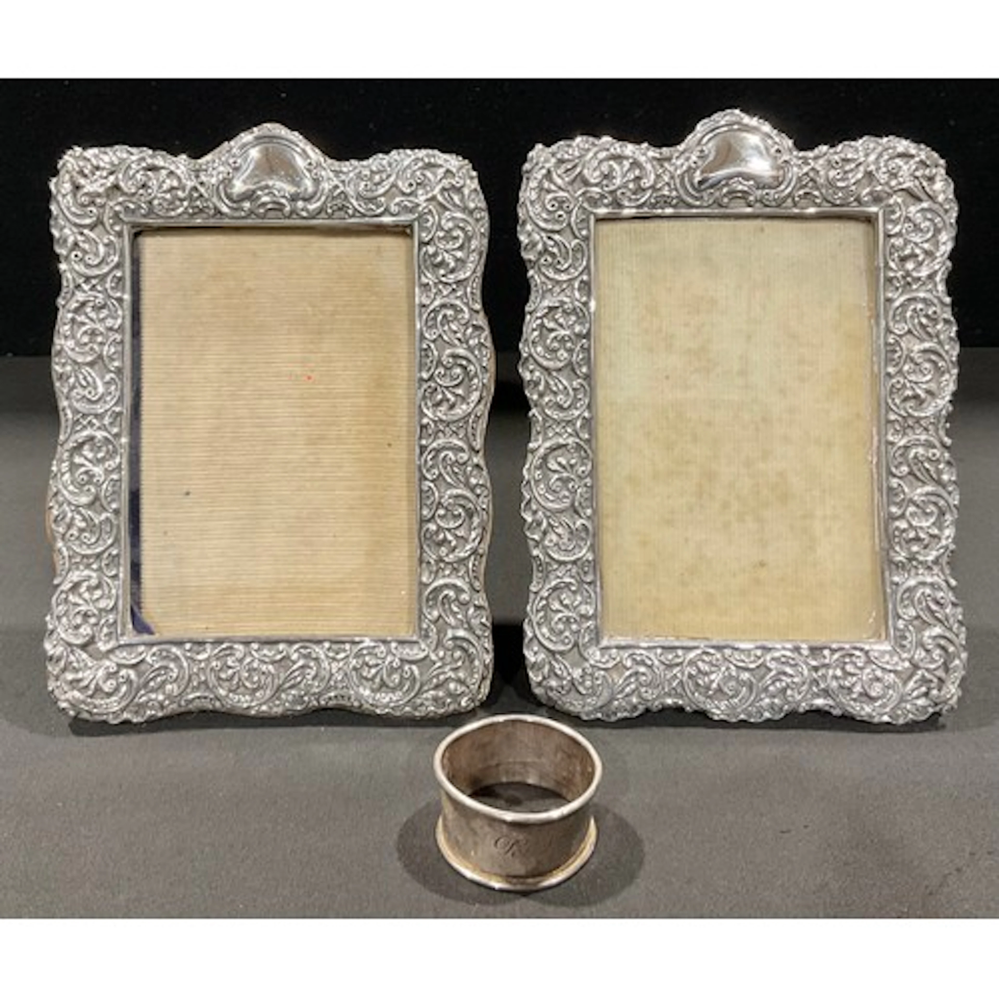 A pair of Victorian silver photograph frames, pierced and em...