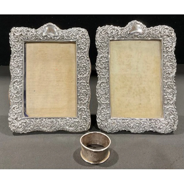A pair of Victorian silver photograph frames, pierced and em...