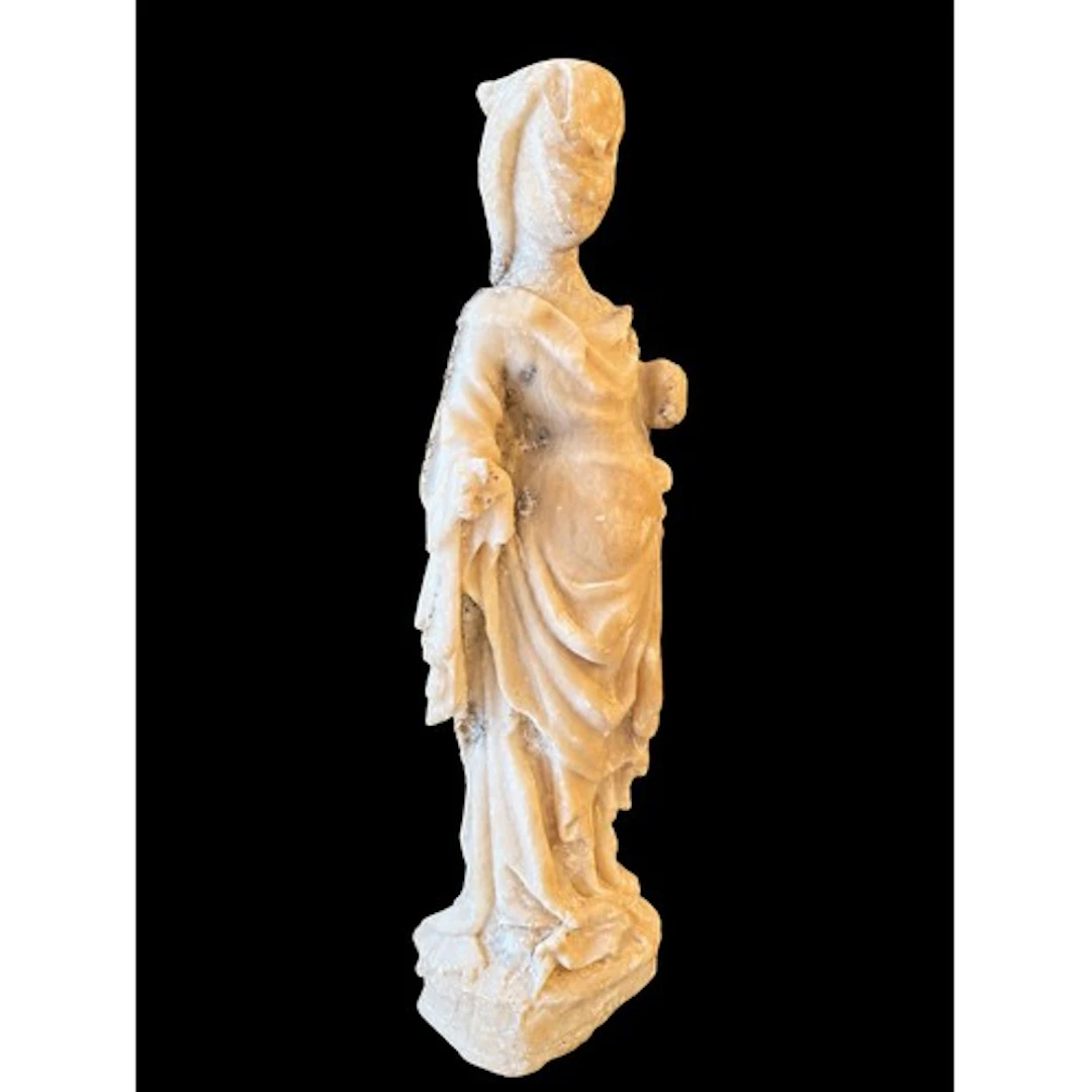A Gothic alabaster figure of the Virgin and Child, the stand...