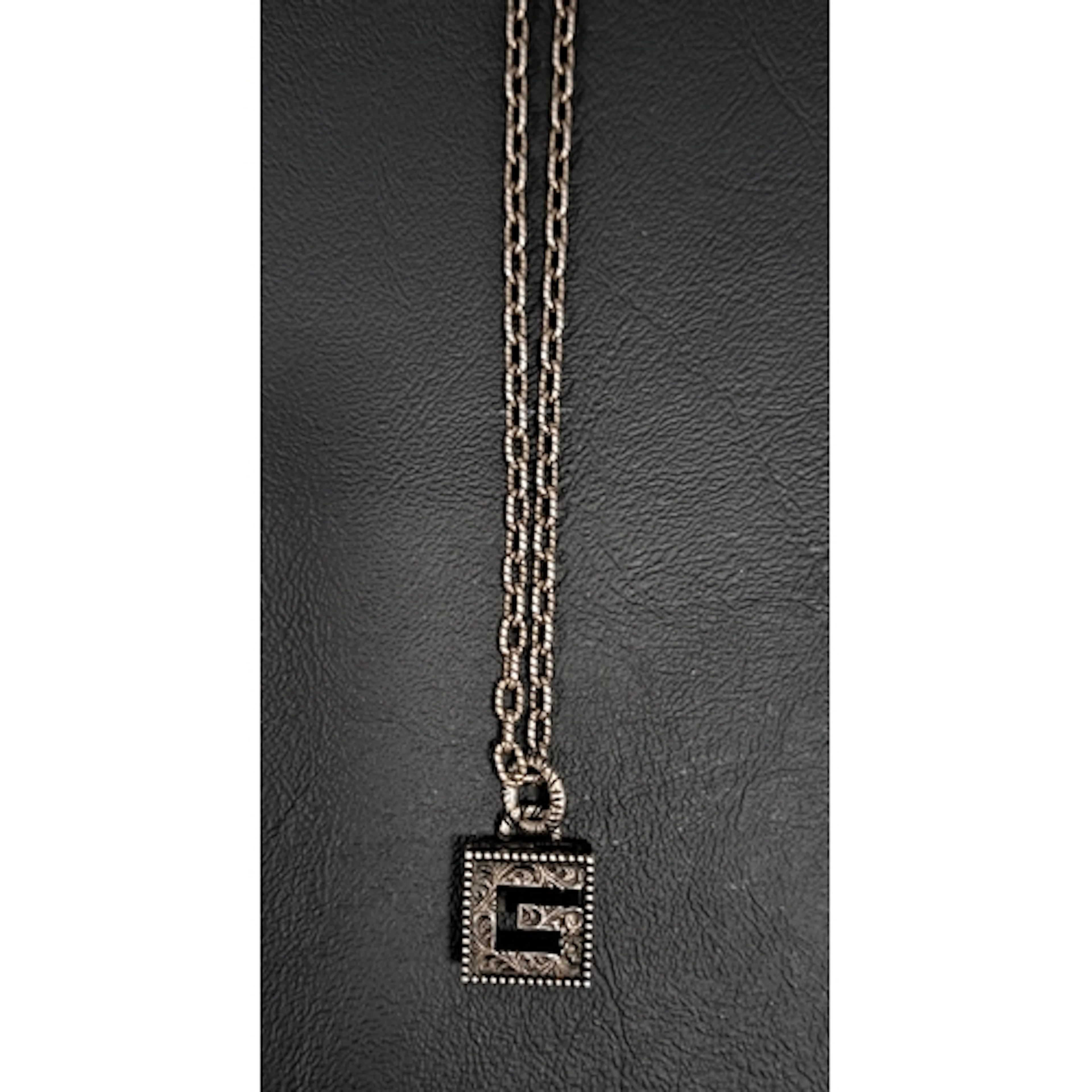GUCCI SILVER CUBE G PENDANT with engraved decoration and wit...