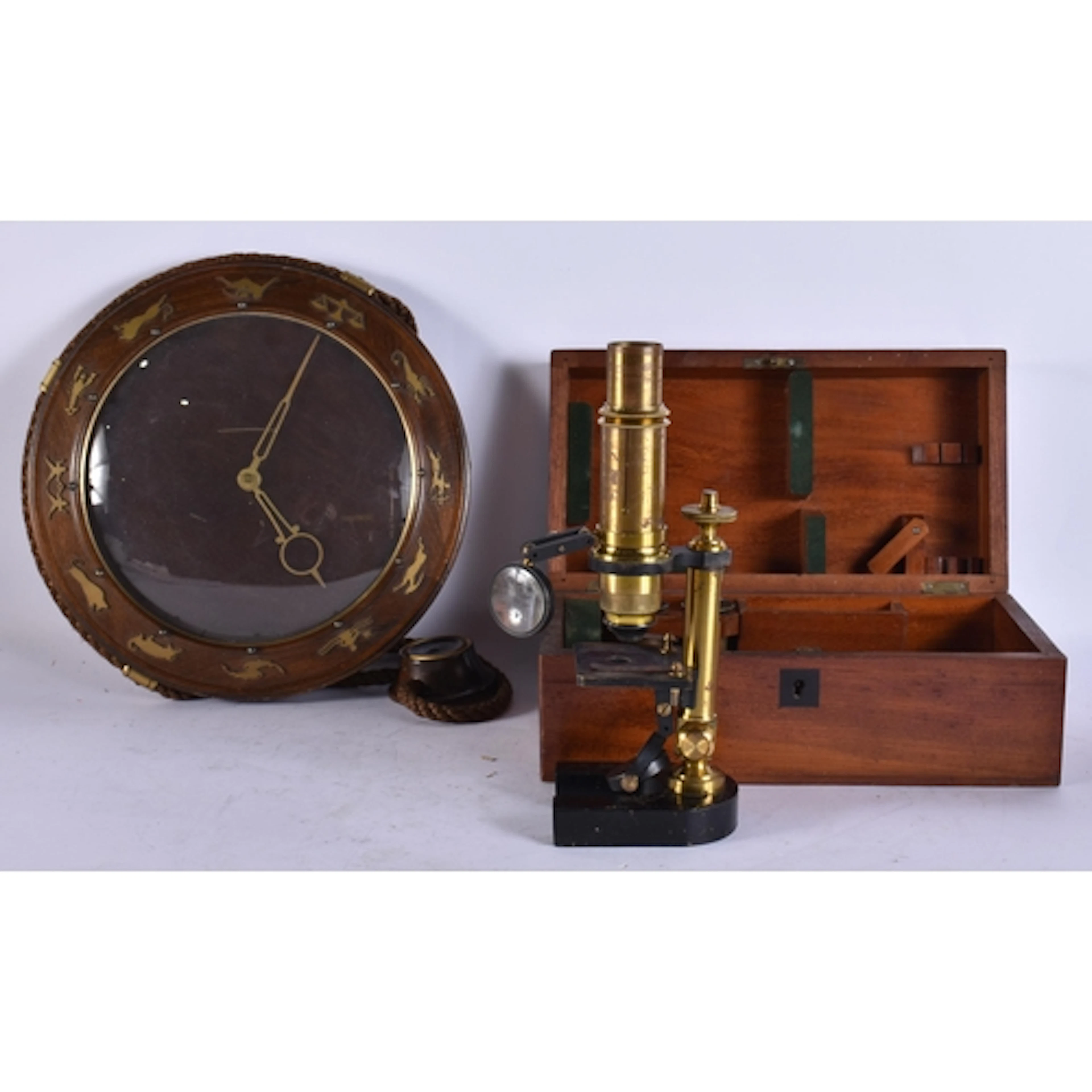 A VINTAGE CLOCK together with a microscope. (2)
