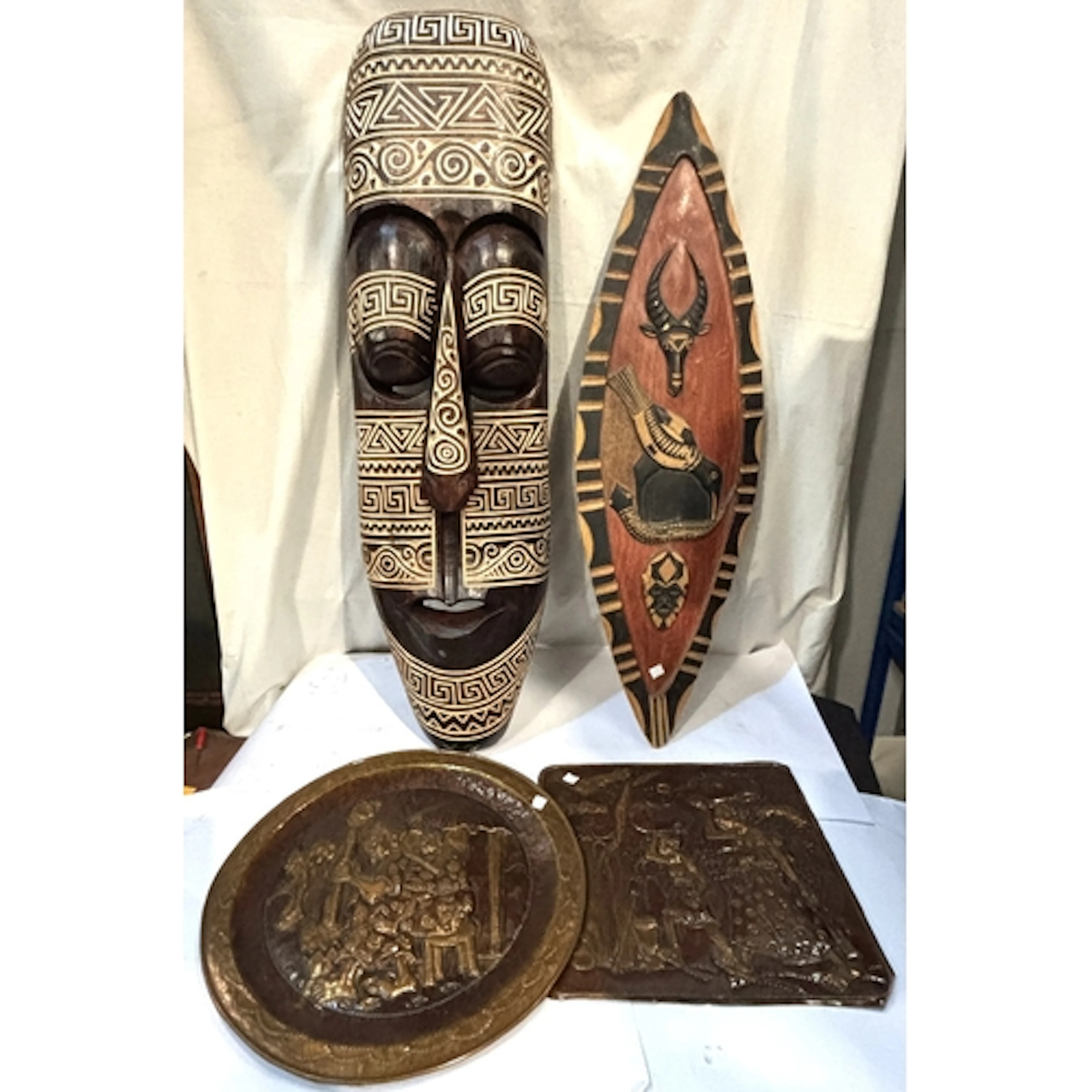 Carved African masks, copper dished and mirrors.