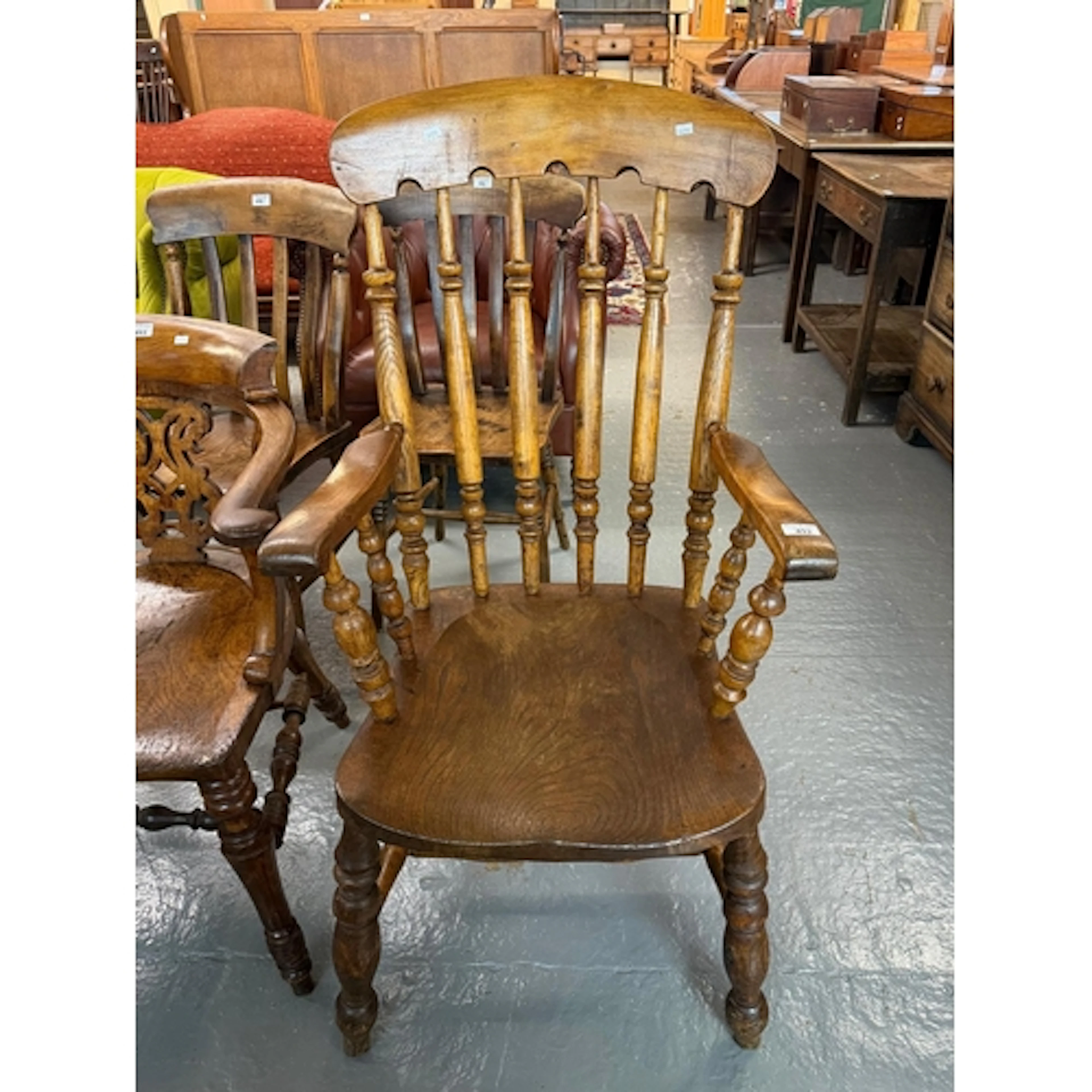 Late Victorian Windsor style armchair, with solid elm saddle...