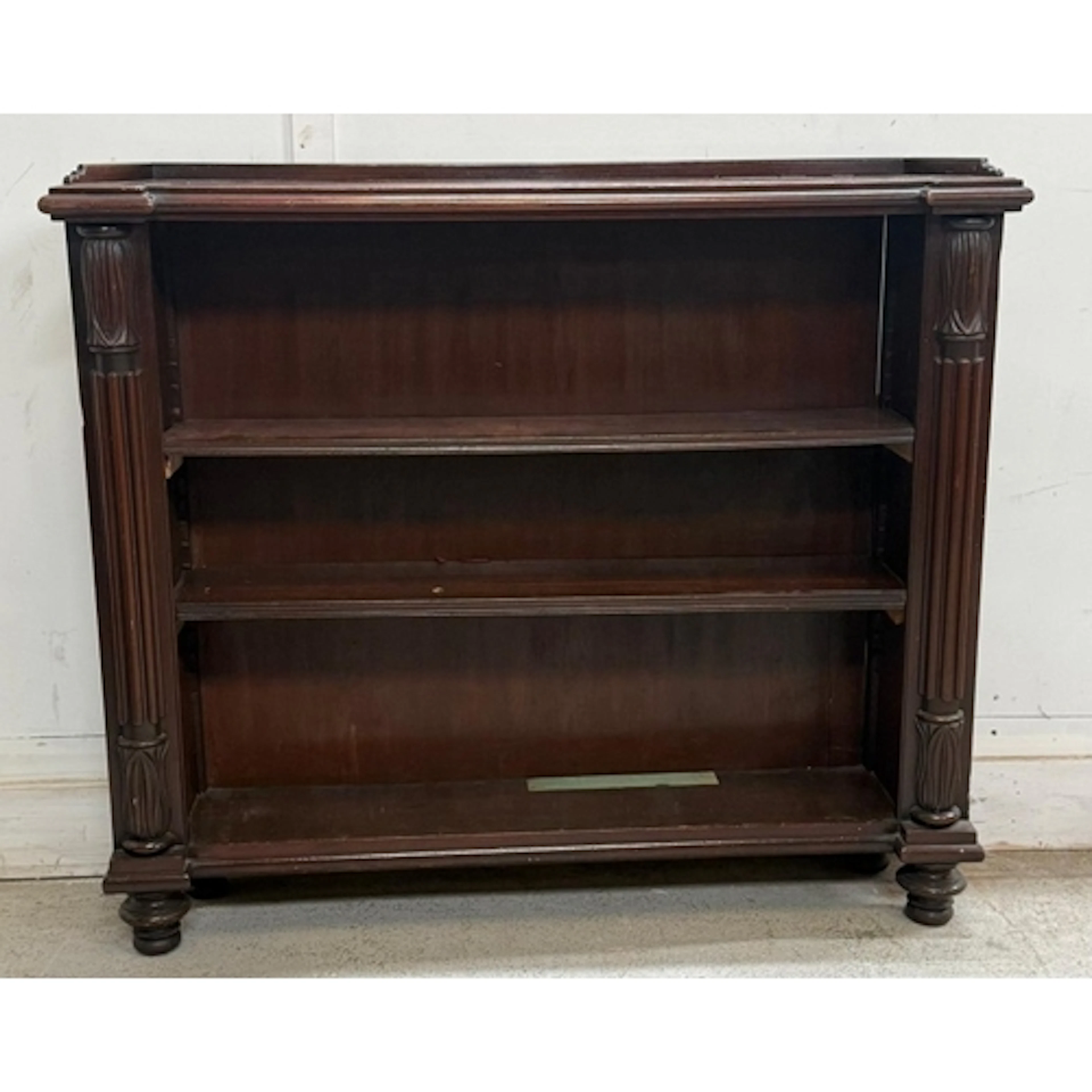 A mahogany two-shelf bookcase with fluted columns to sides H...