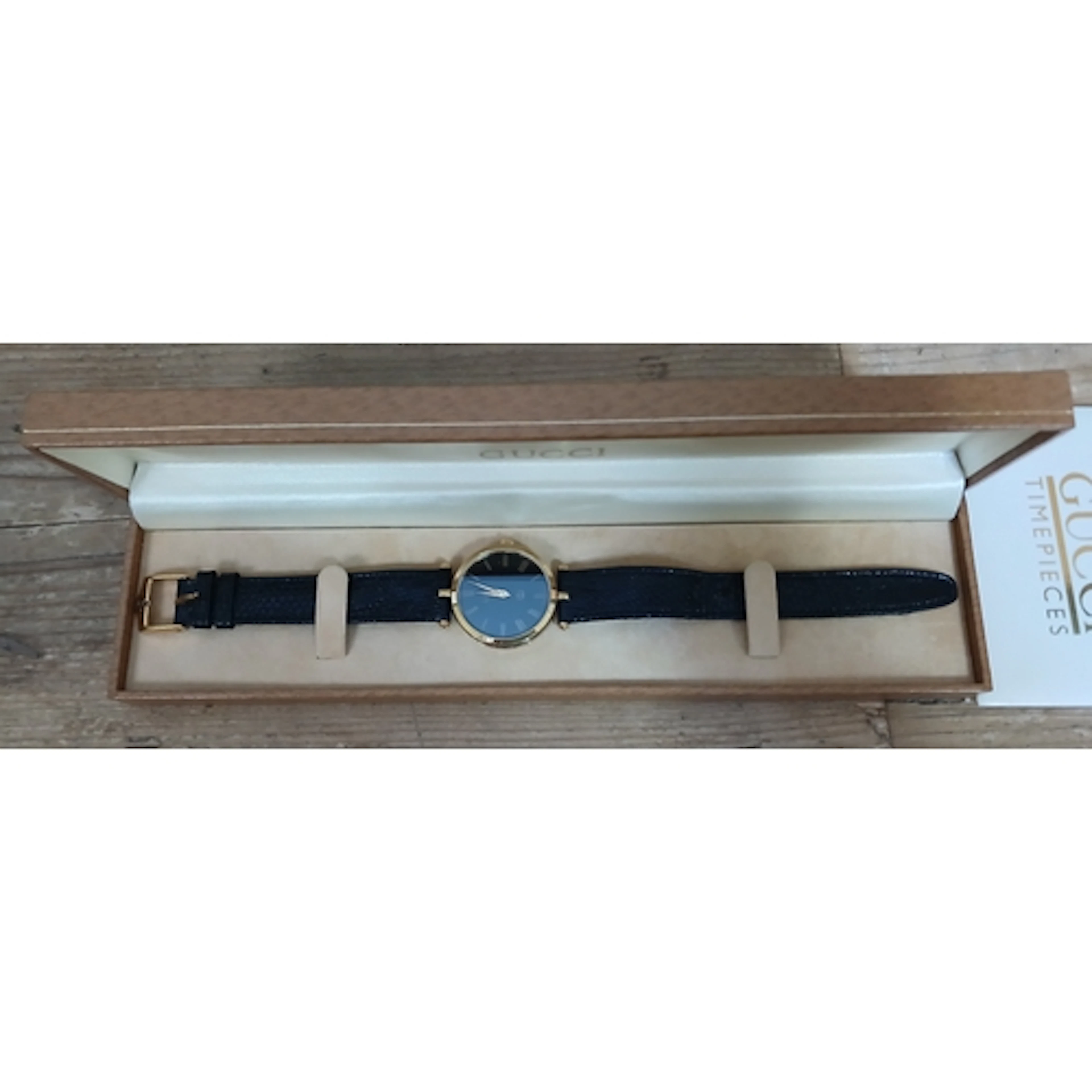 GUCCI, a ladies gold palted black dial wristwatch with leath...
