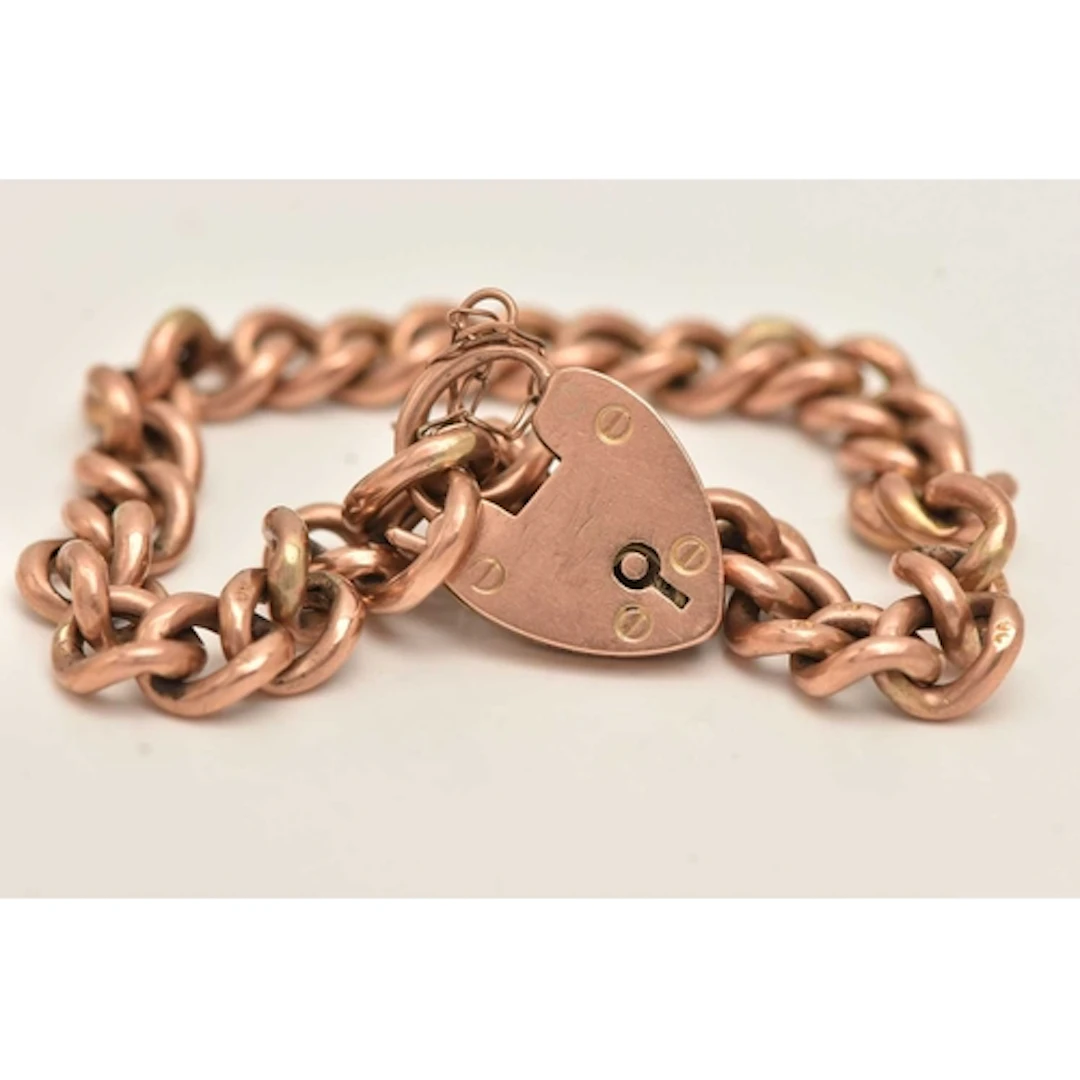 A ROSE METAL CURB LINK BRACELET, hollow curb links stamped 9...