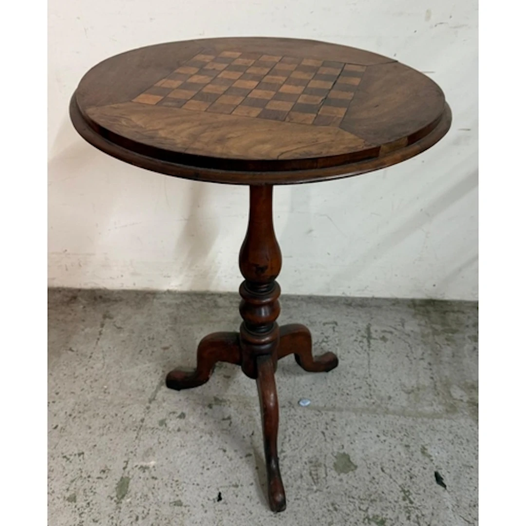 A circular Victorian mahogany chess table with turned centra...