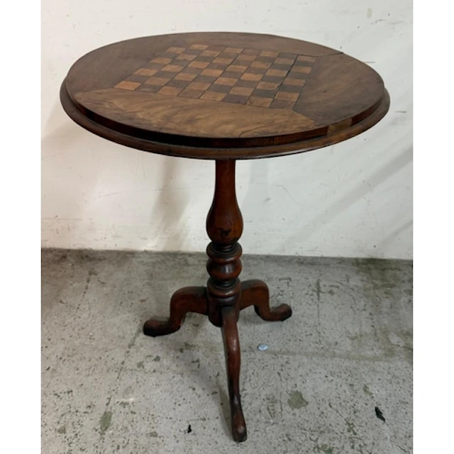 A circular Victorian mahogany chess table with turned centra...