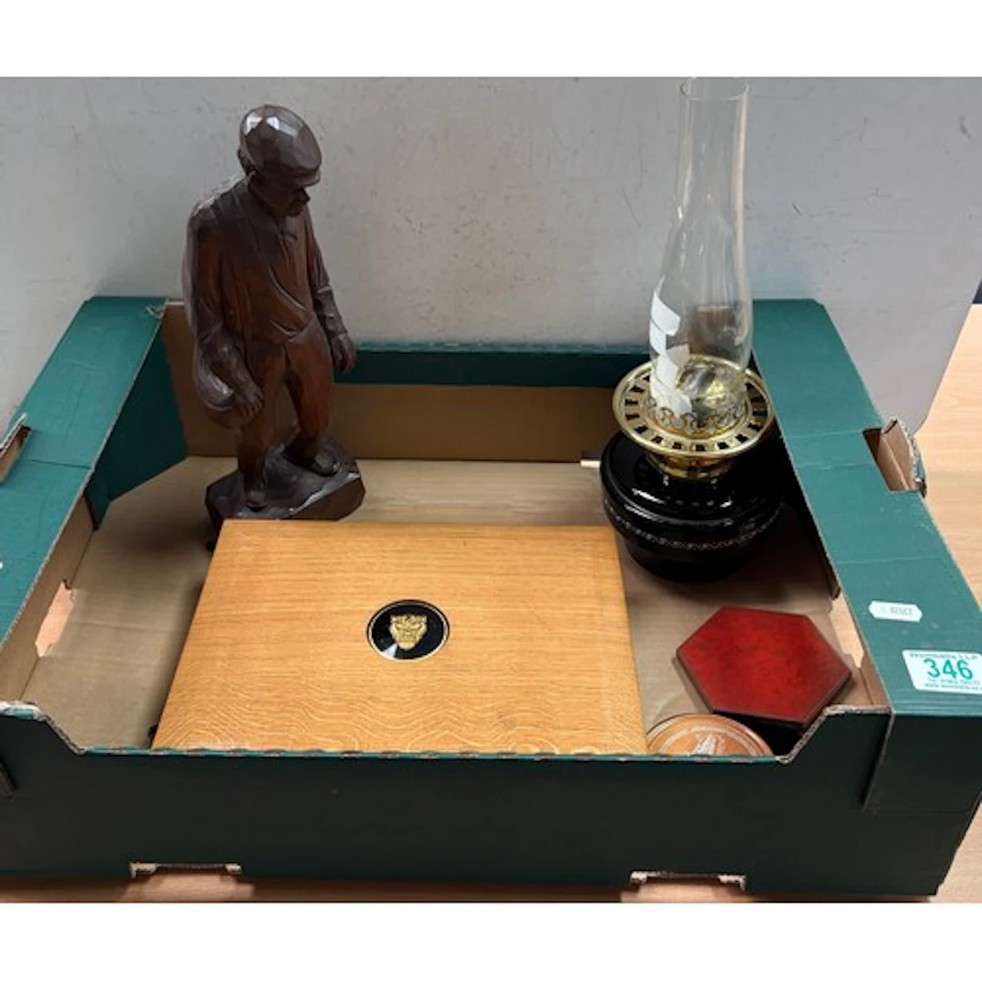 An oak box containing Jaguar car placemats, carved figure an...