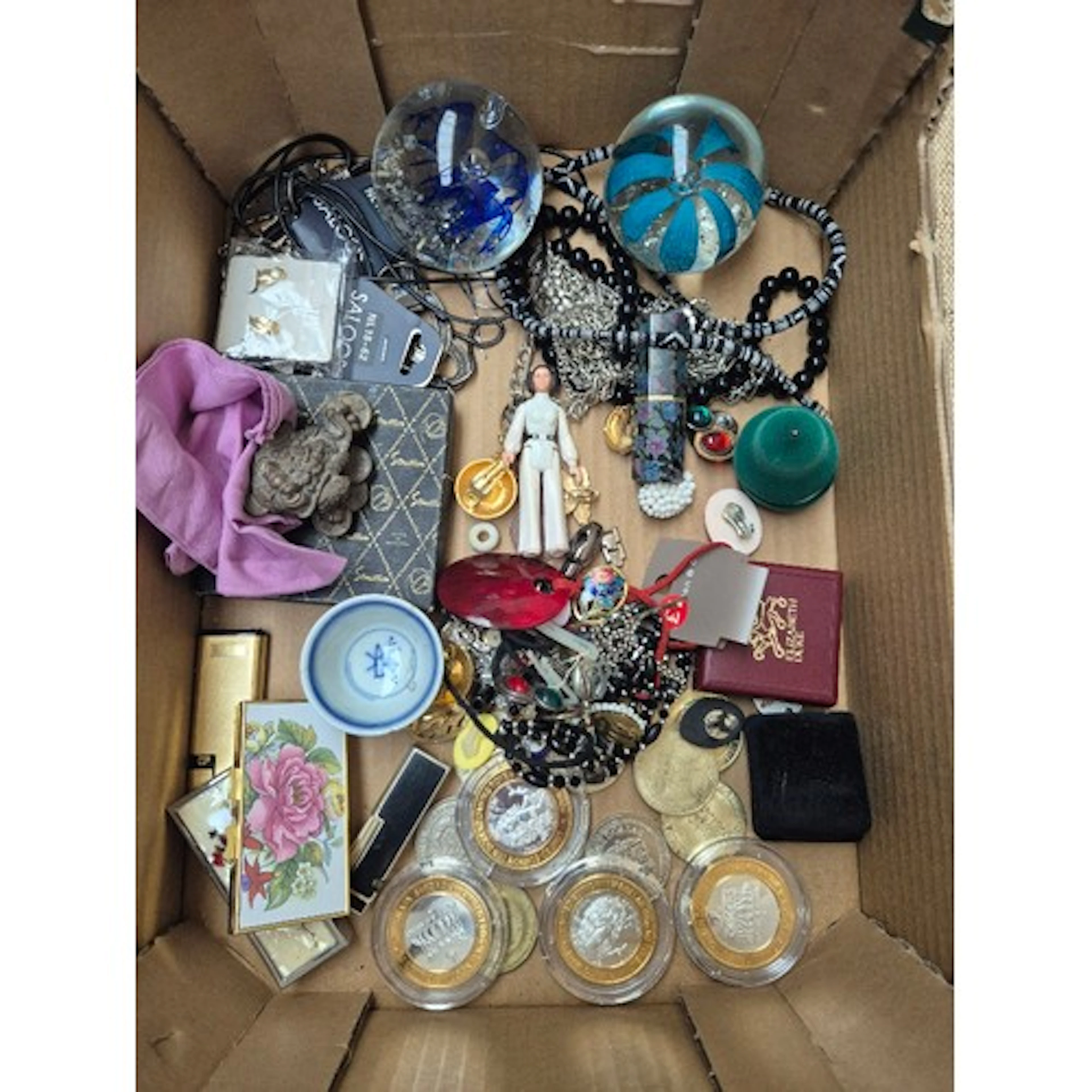A box of assorted collectables to include commemorative coin...