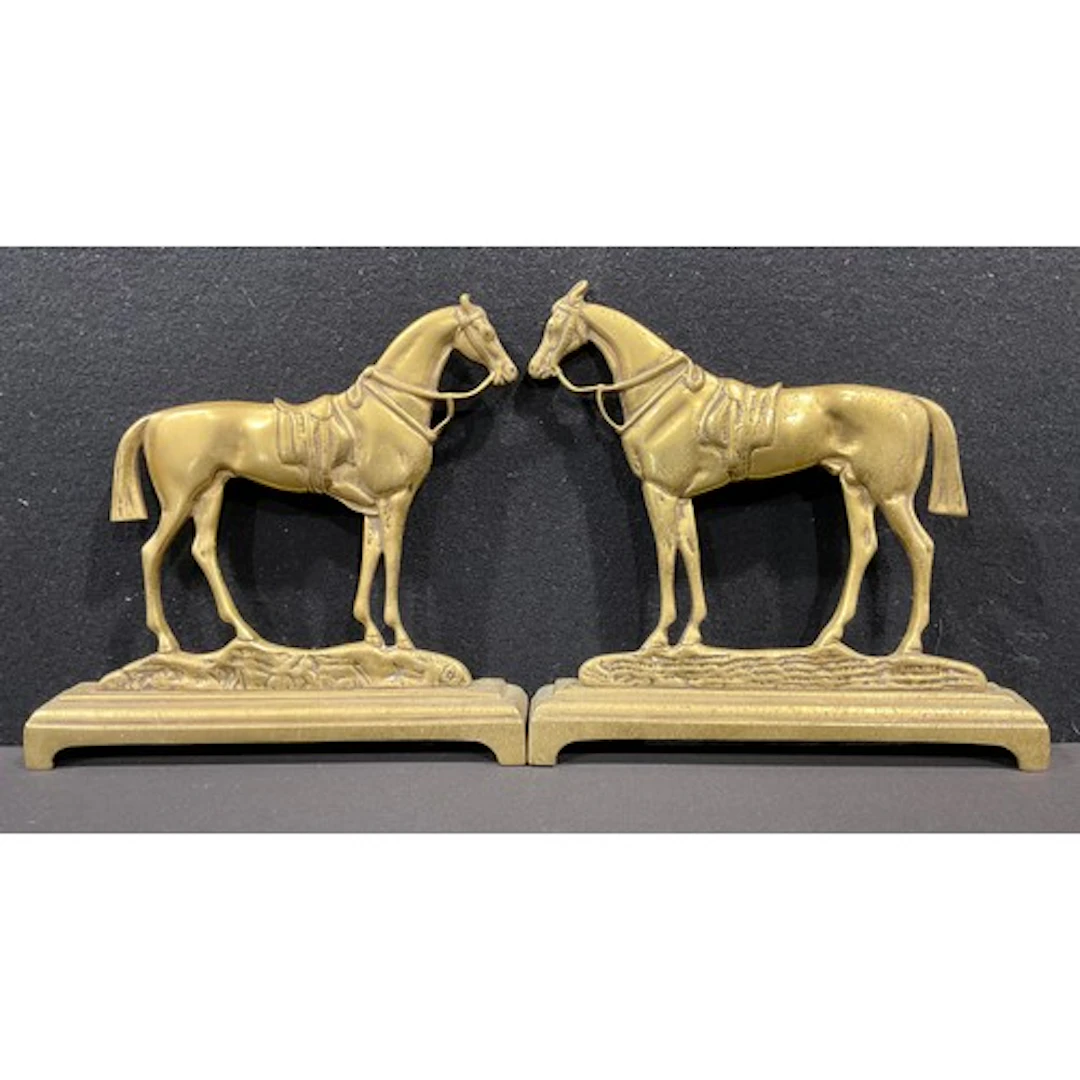 A pair of 19th century brass hearth ornaments, presented as ...