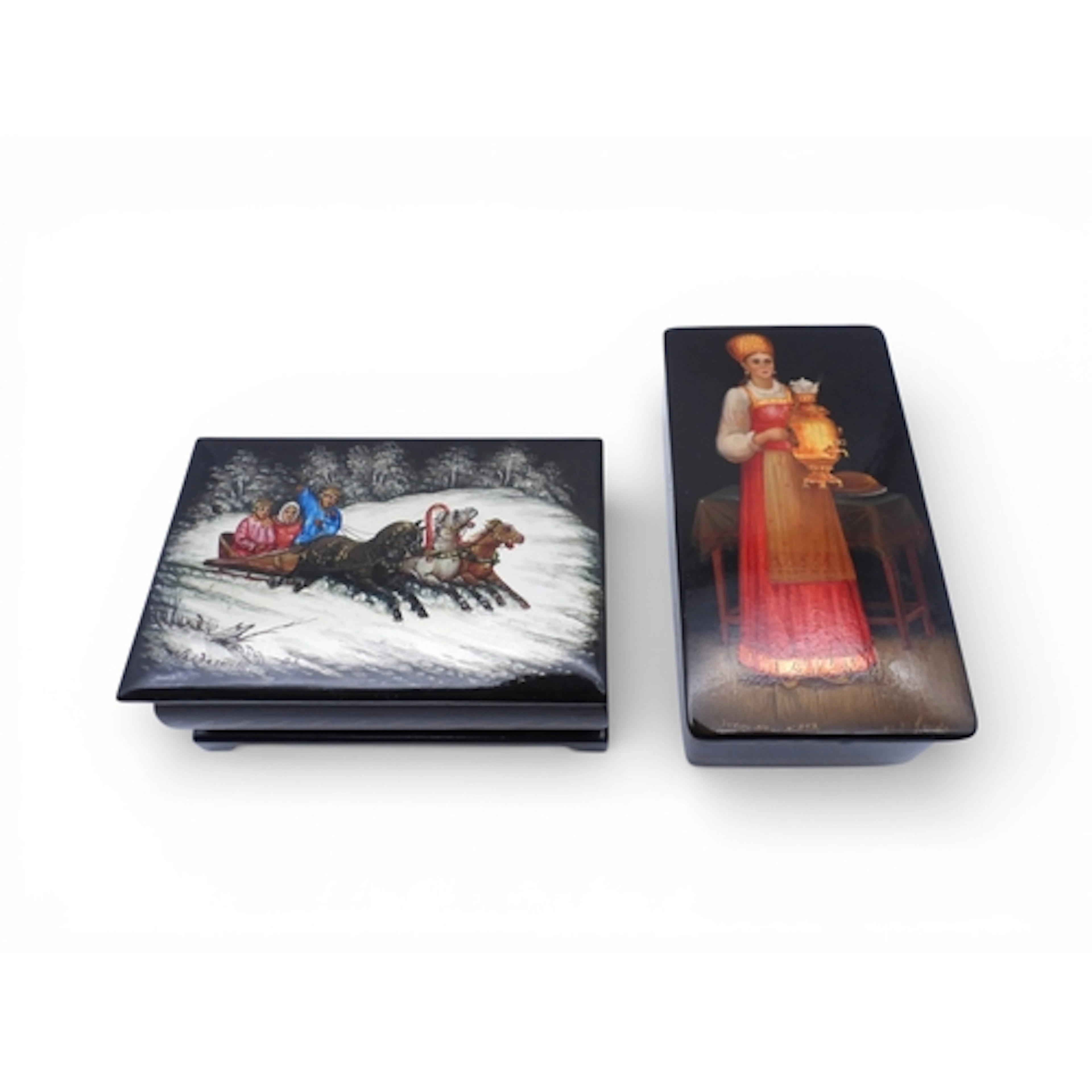Two Russian lacquer boxes, one painted with a family sleddin...