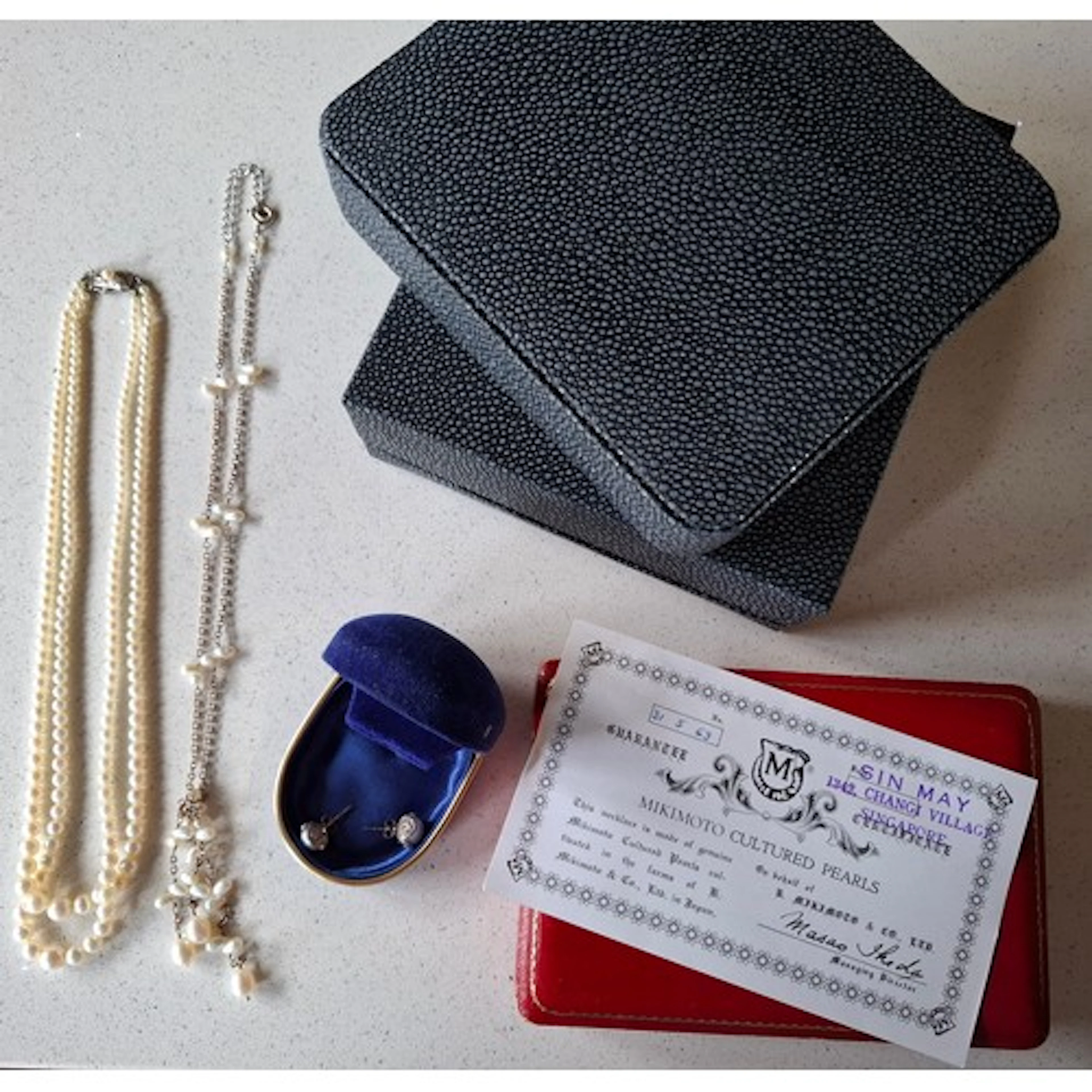 A 1969 2-strand Mikimoto pearl necklace having a silver clas...