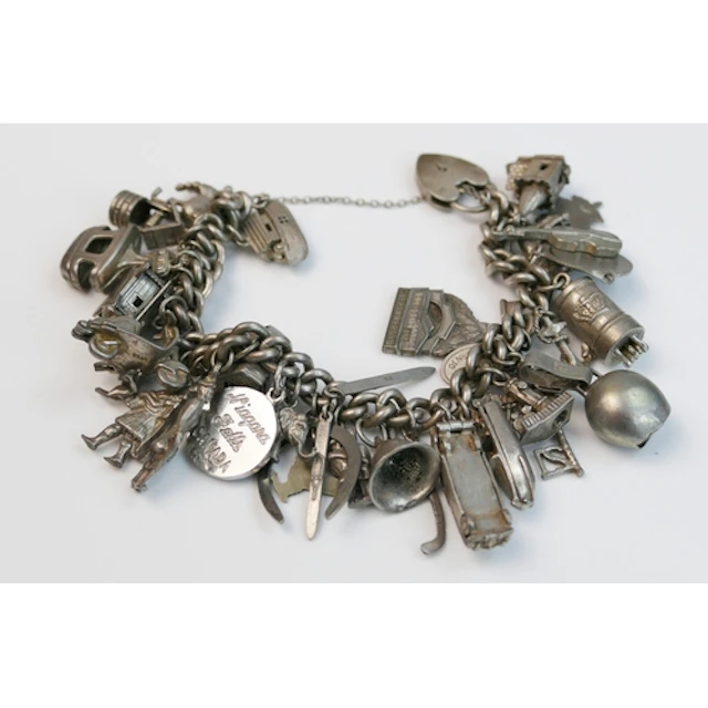 A silver charm bracelet with heart padlock clasp, some charm...