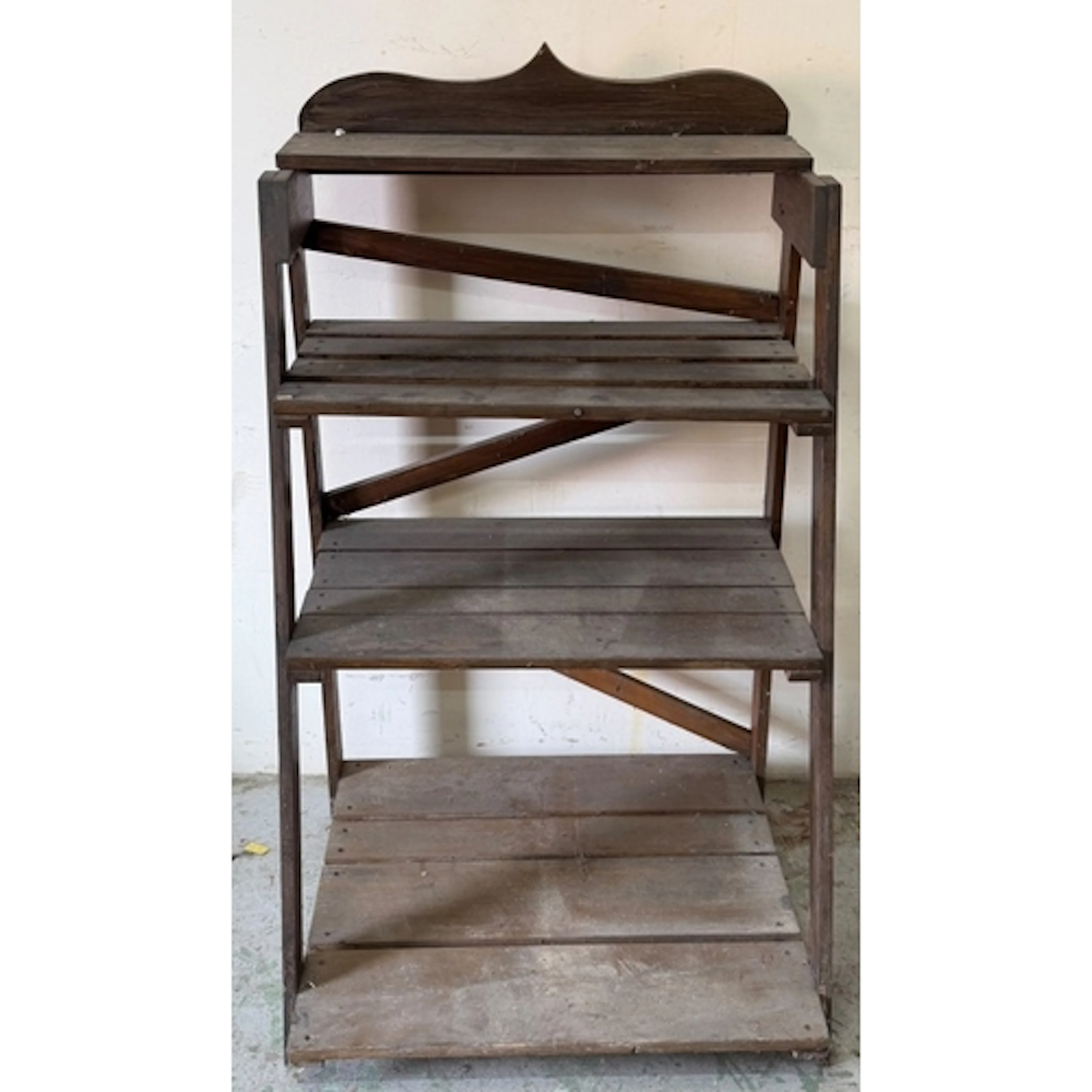 A wooden three tier plant stand
