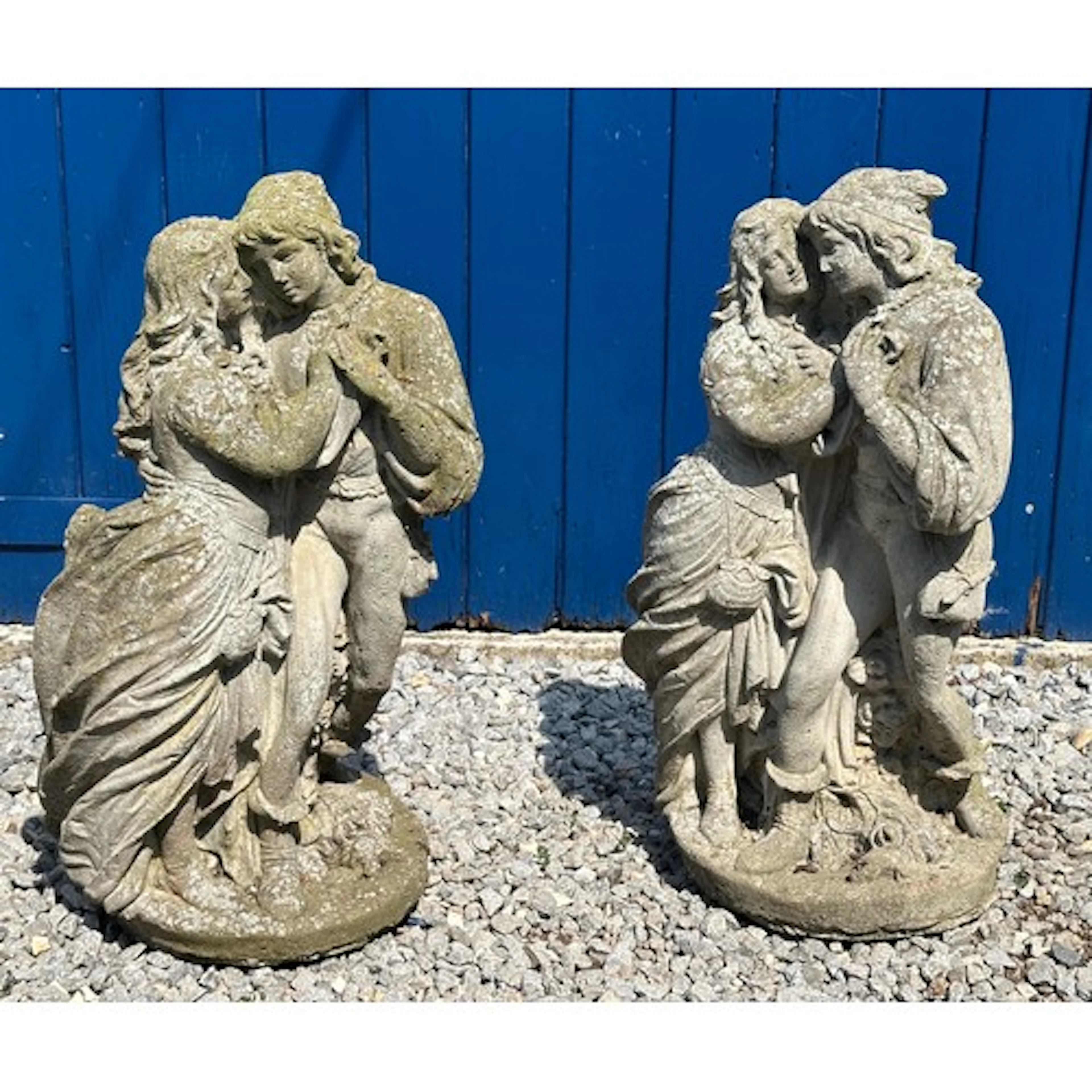 Two reconstituted stone garden figures, both of courting cou...