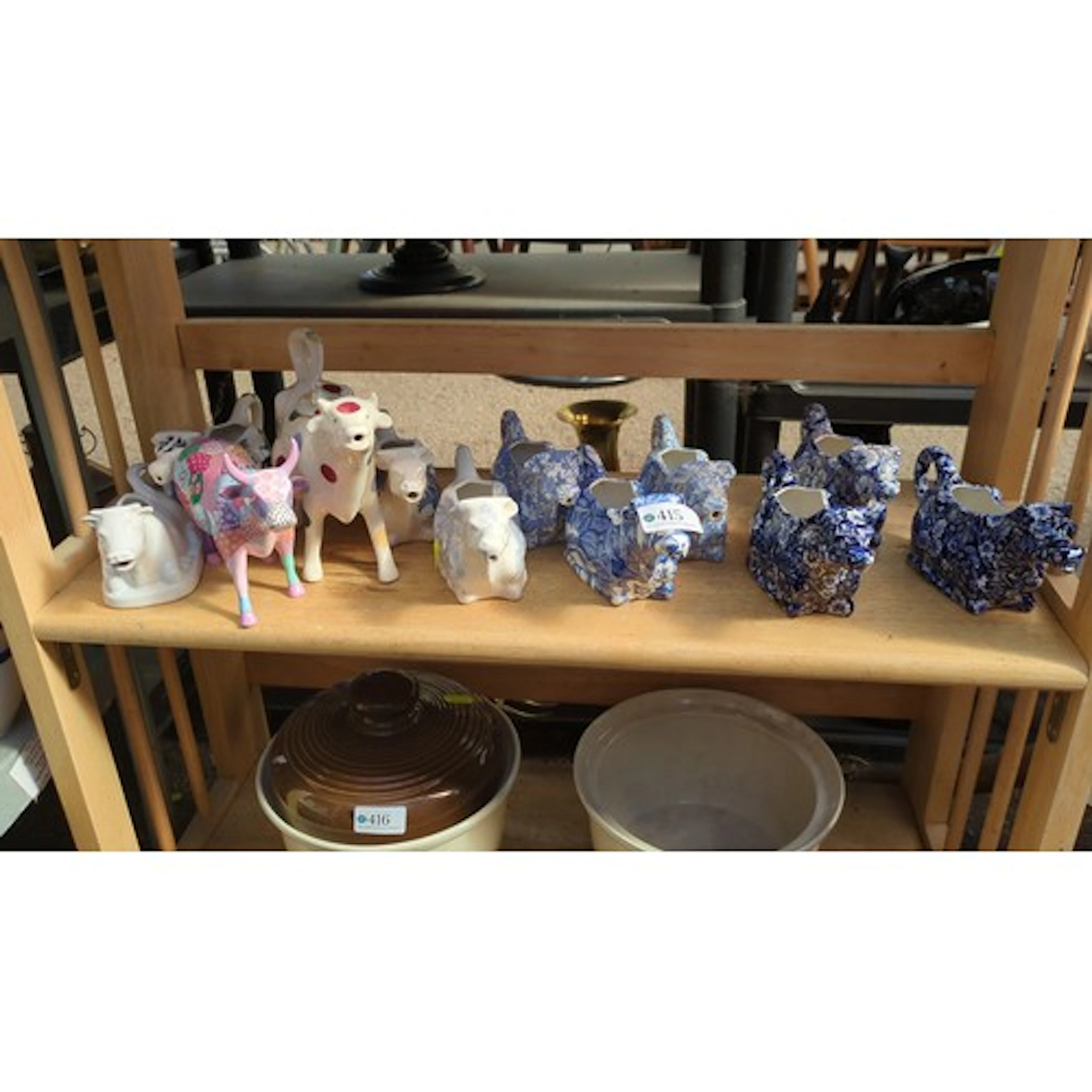 A quantity of ceramic cow-form creamers, some bearing factor...