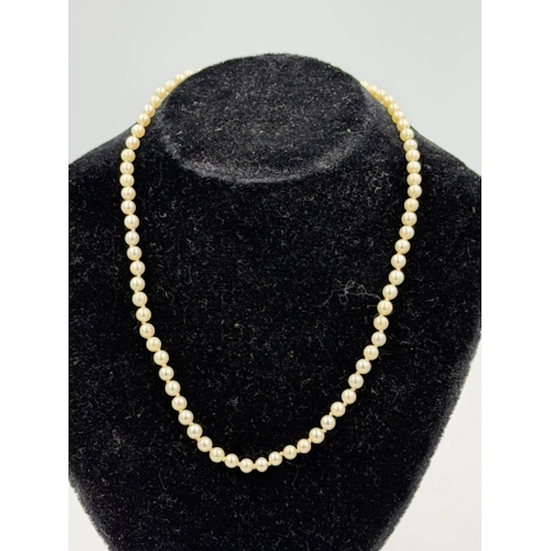 A pearl necklace with hallmarked 9ct gold clasp, approximate...