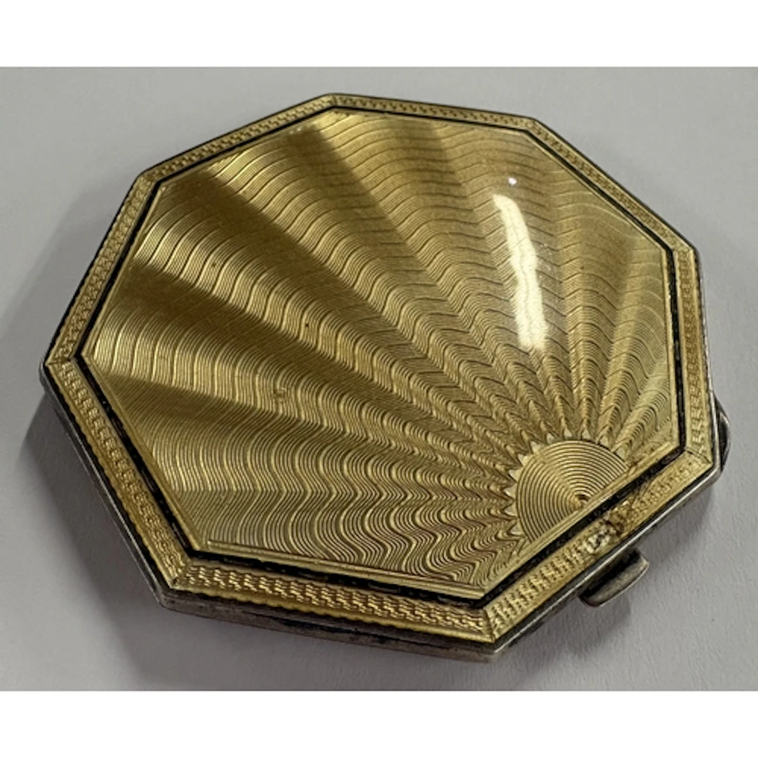 A silver and yellow enamelled compact. Birmingham 1940. Appr...