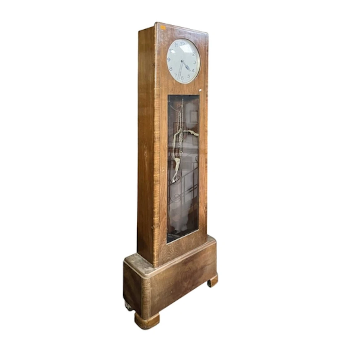 An Art Deco early 20th century walnut cased longcase clock. ...