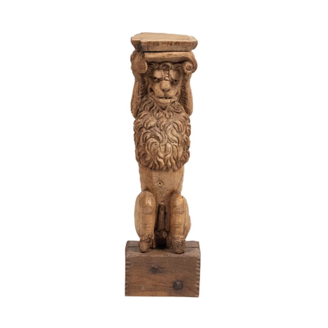 A carved oak herm or pilaster support modelled as a lion, la...