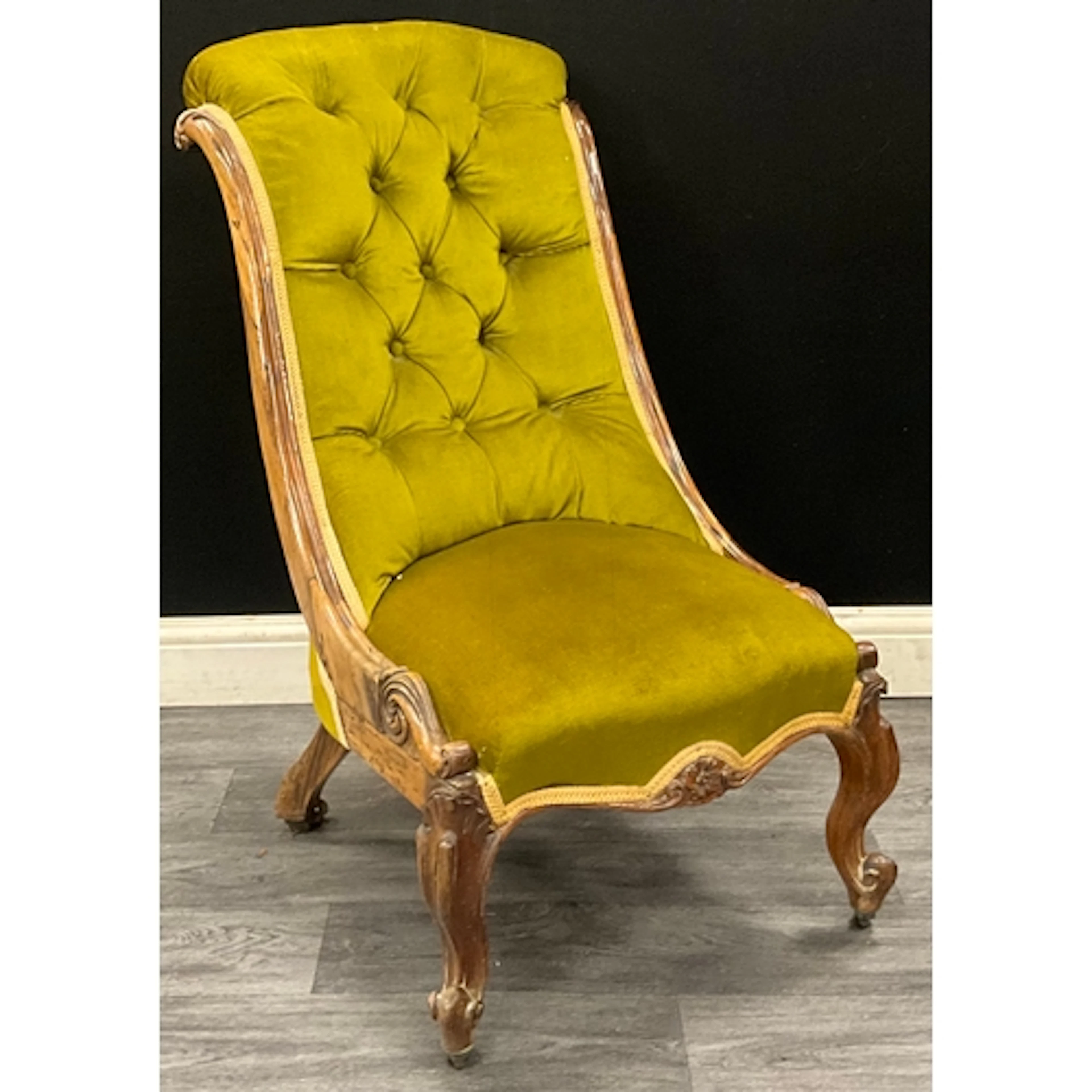 A Victorian walnut nursing chair, green button-back upholste...