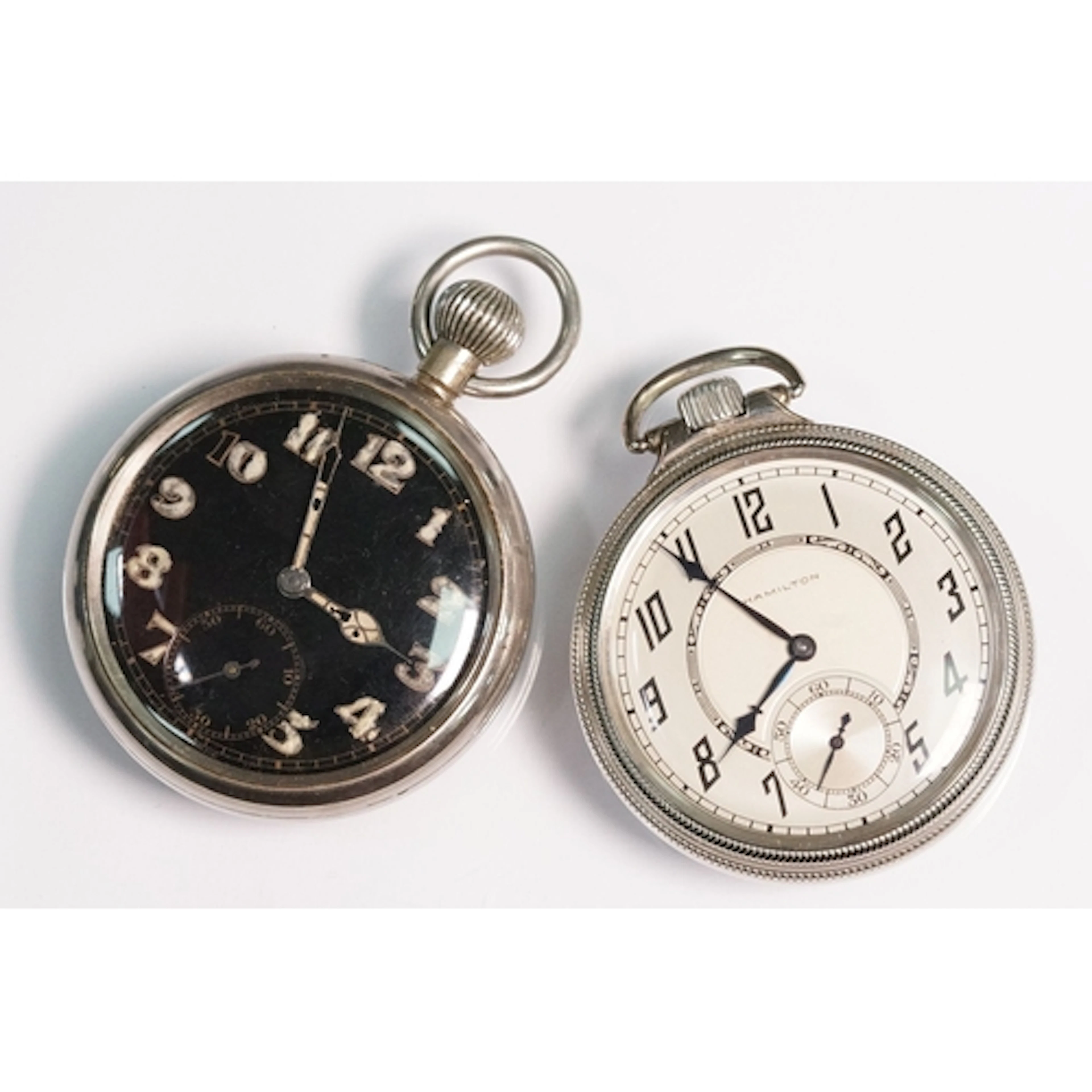 Military pocket watch having a black face with luminous arab...