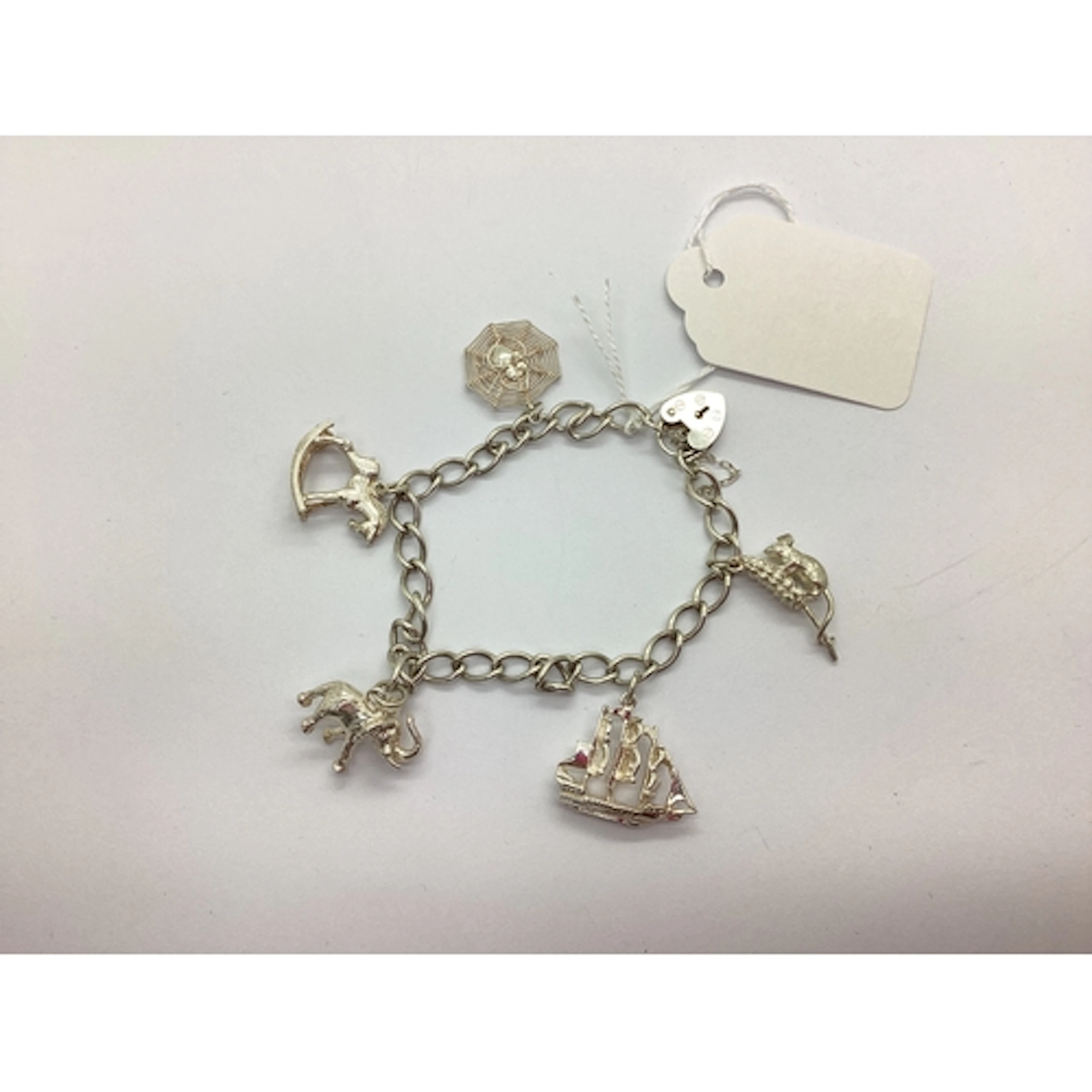 A Hallmarked Silver Curb Link Bracelet, suspending five nove...
